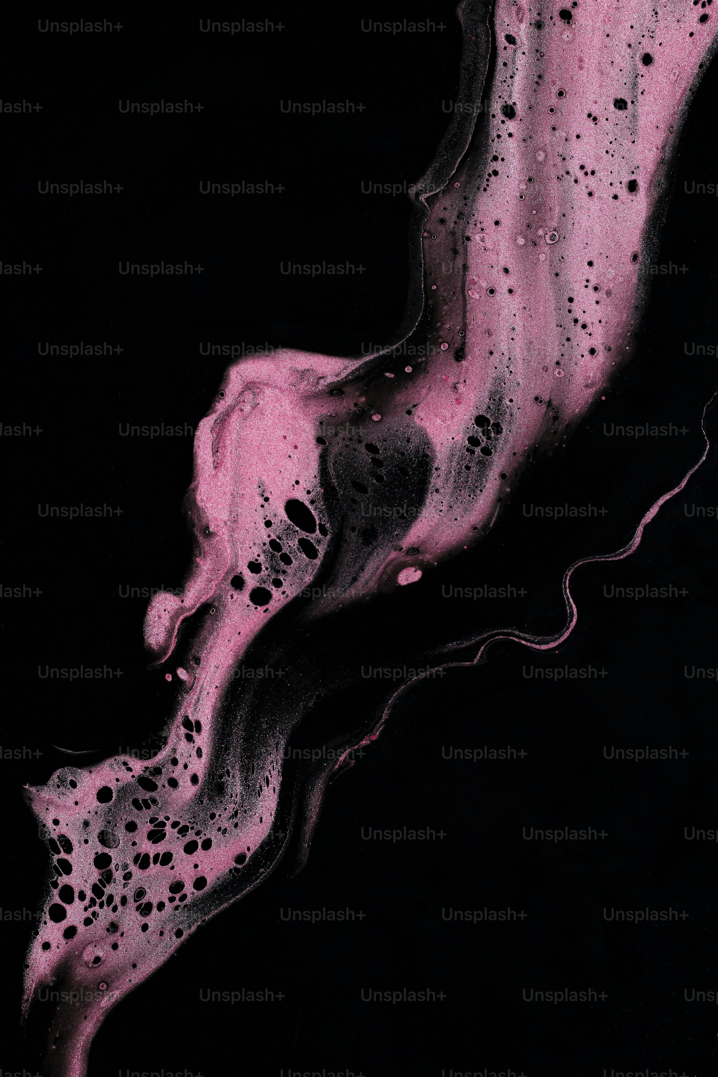 A black and pink painting on a black background photo