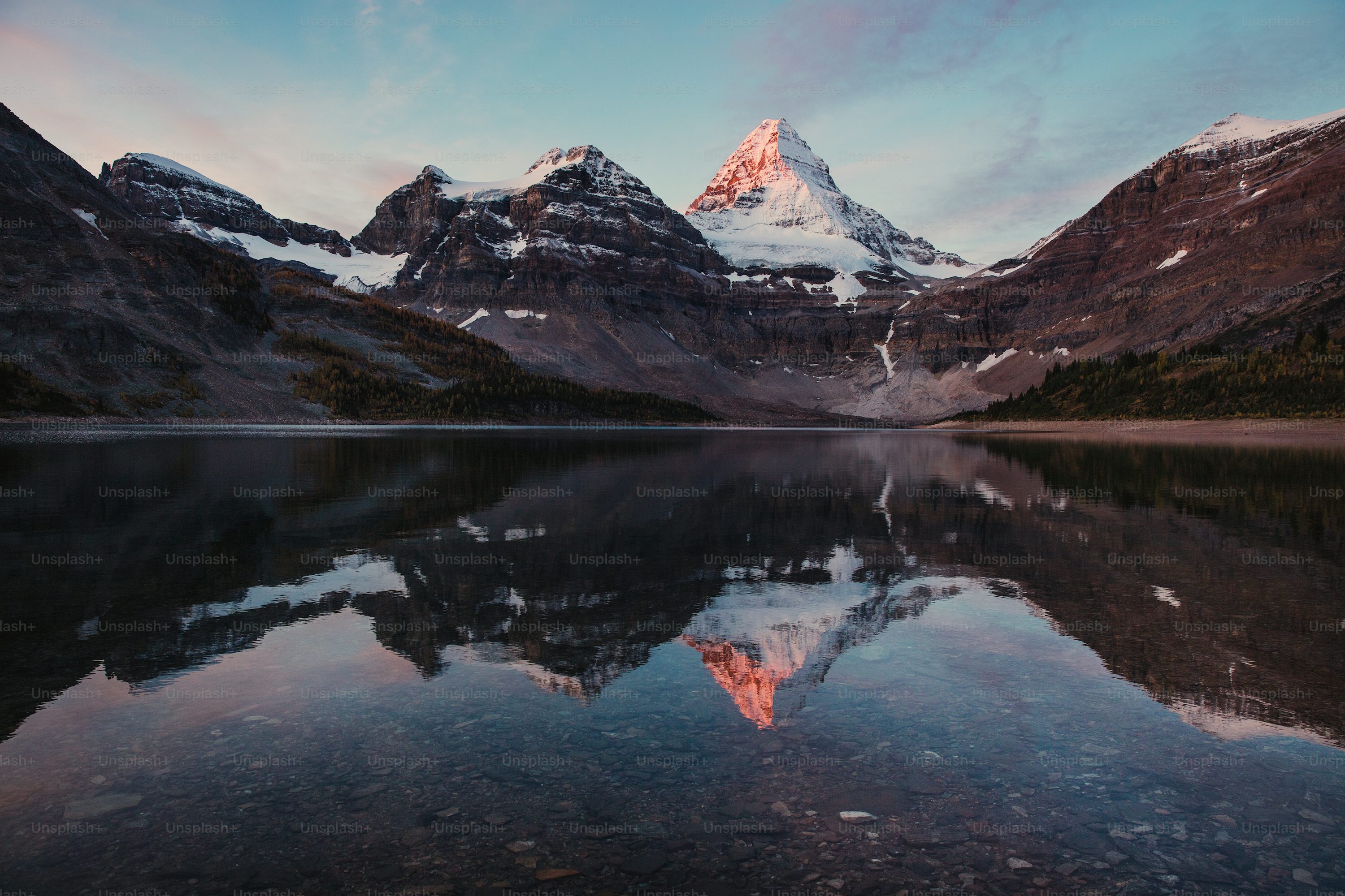 A mountain is reflected in the still water of a lake photo
