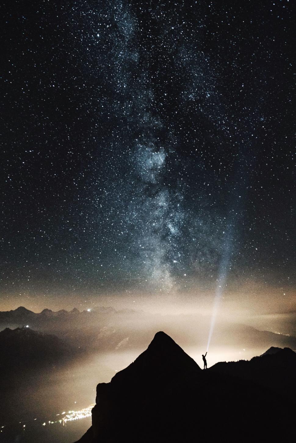 Free of Person shining a light into the milky way. Download Free Image and Free Illustrations