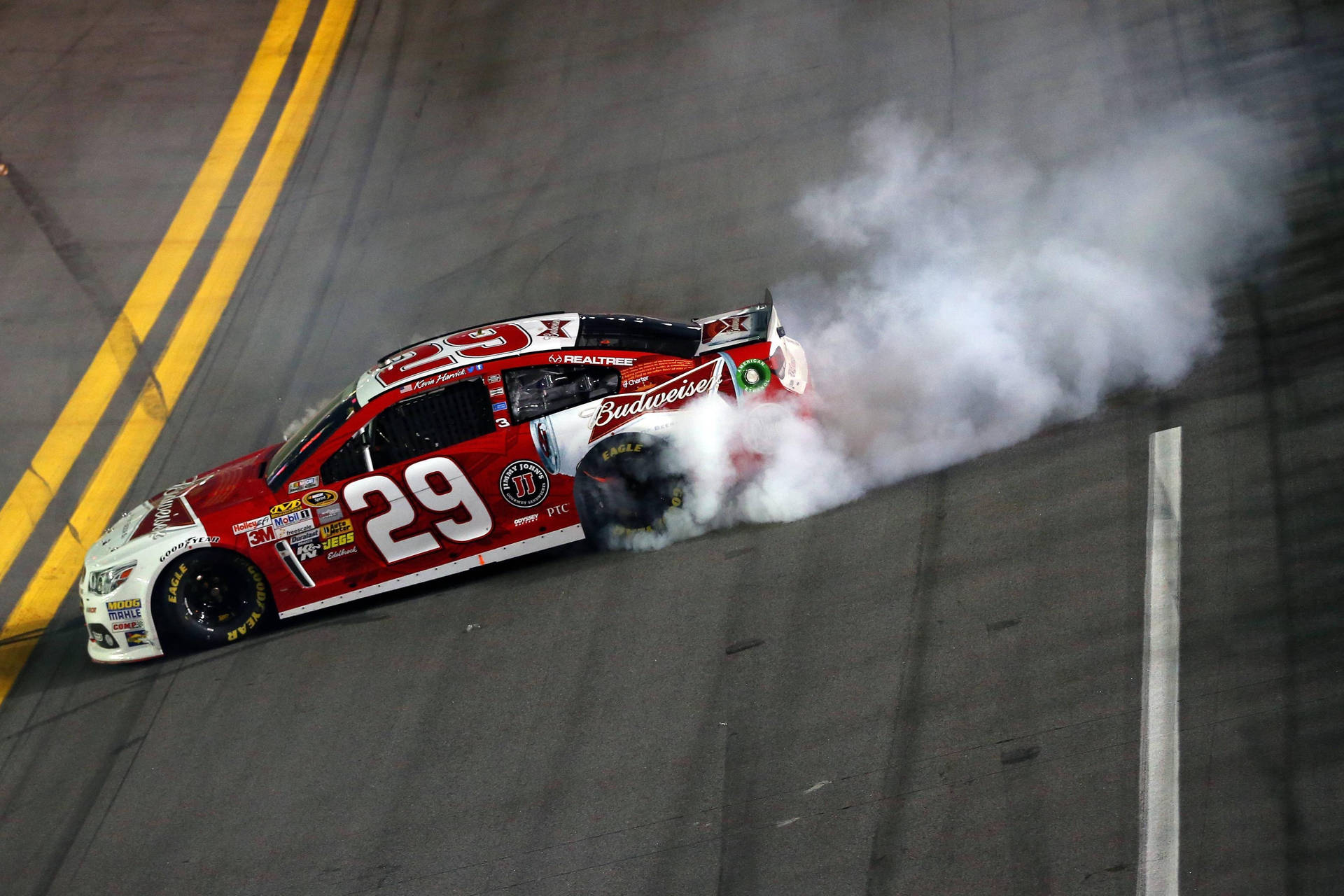 Download Kevin Harvick Burning Rubber on Race Track Wallpaper