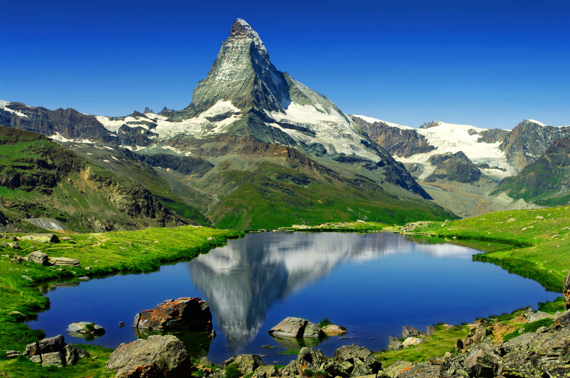 Download Majestic Matterhorn Reflection on the Serene Alpine Lake Wallpaper