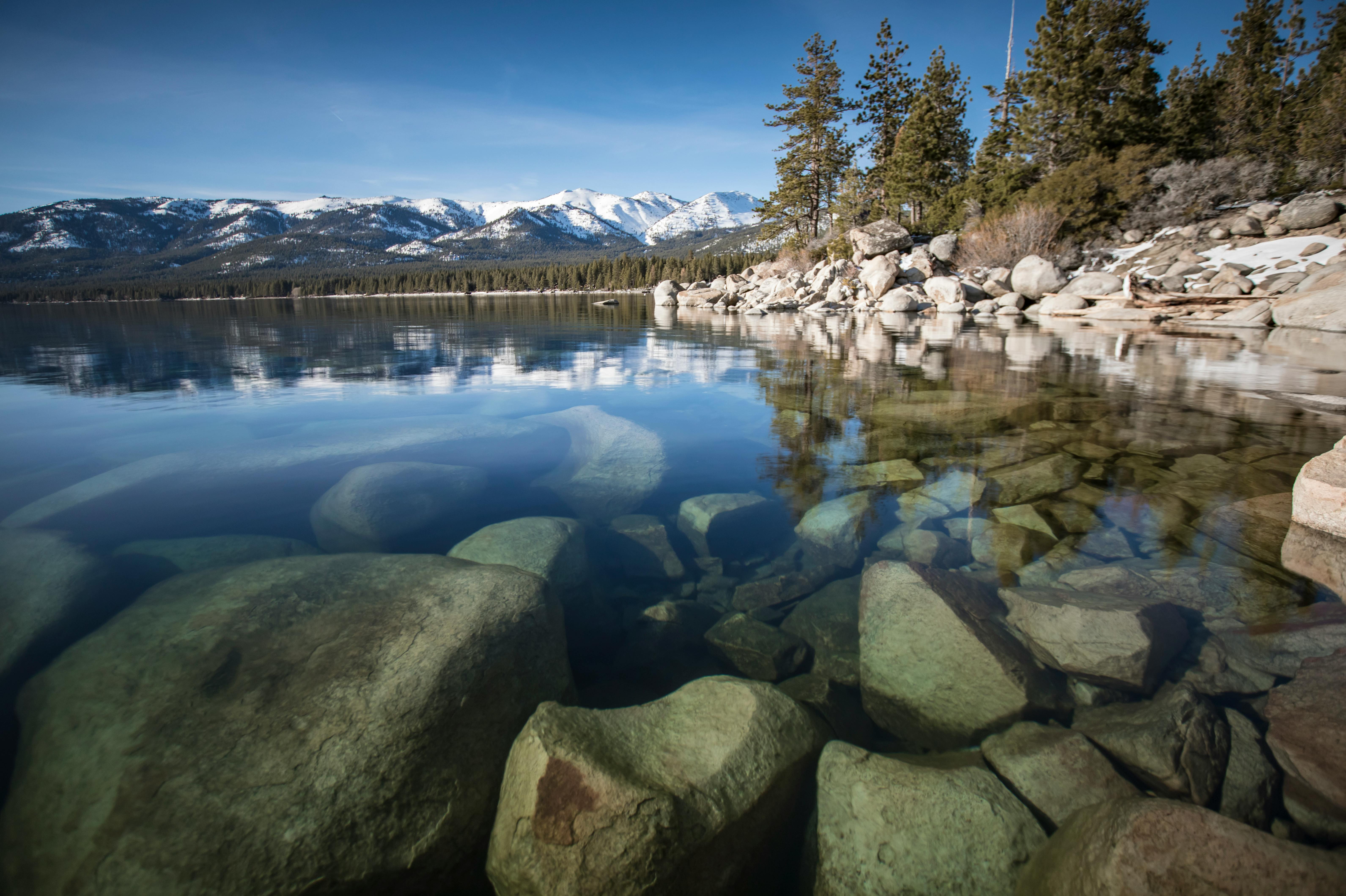 Serene Lake Tahoe with Rocky Shoreline and Mountains · Free