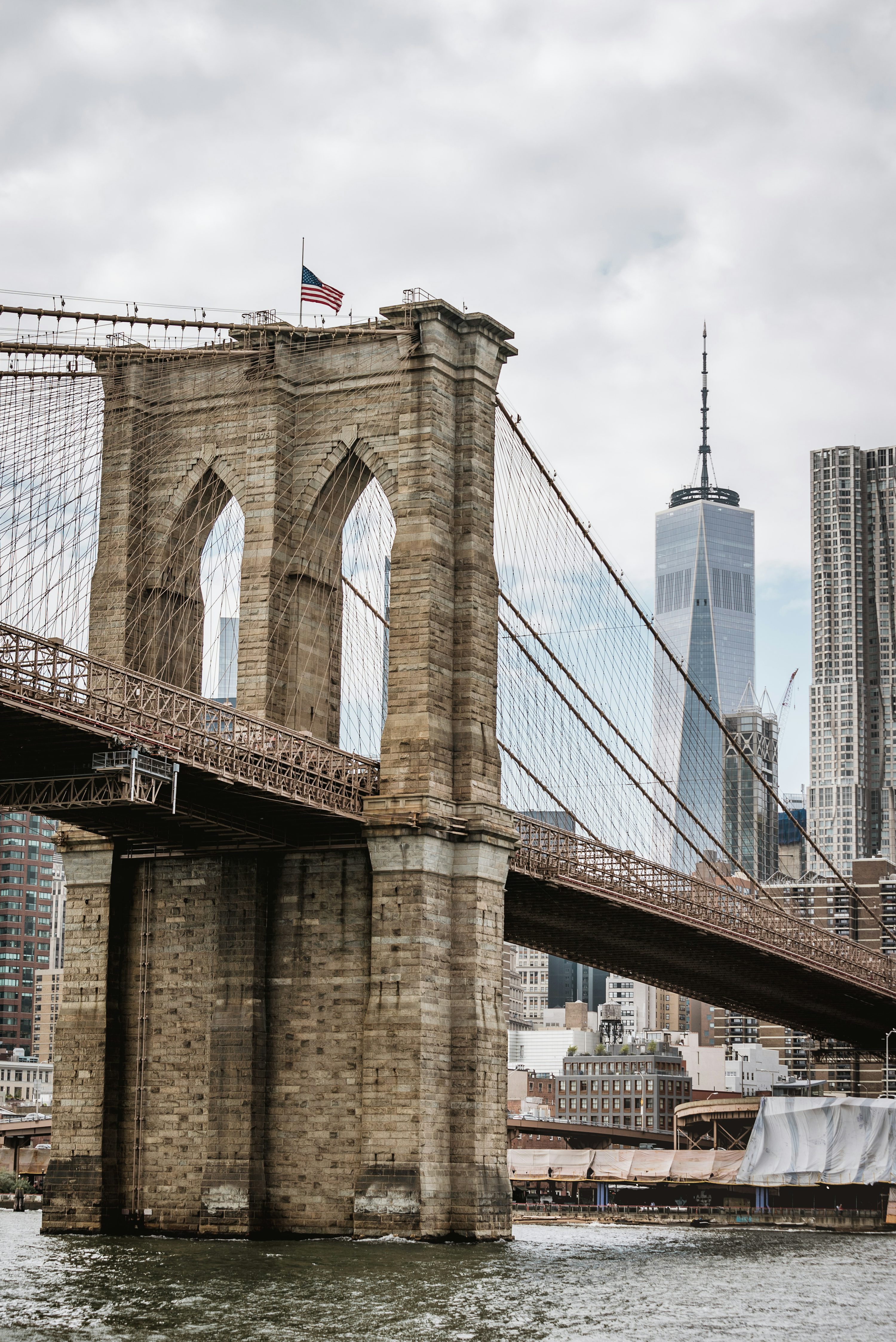 Brooklyn Bridge, New York under cloudy sky during daytime photo