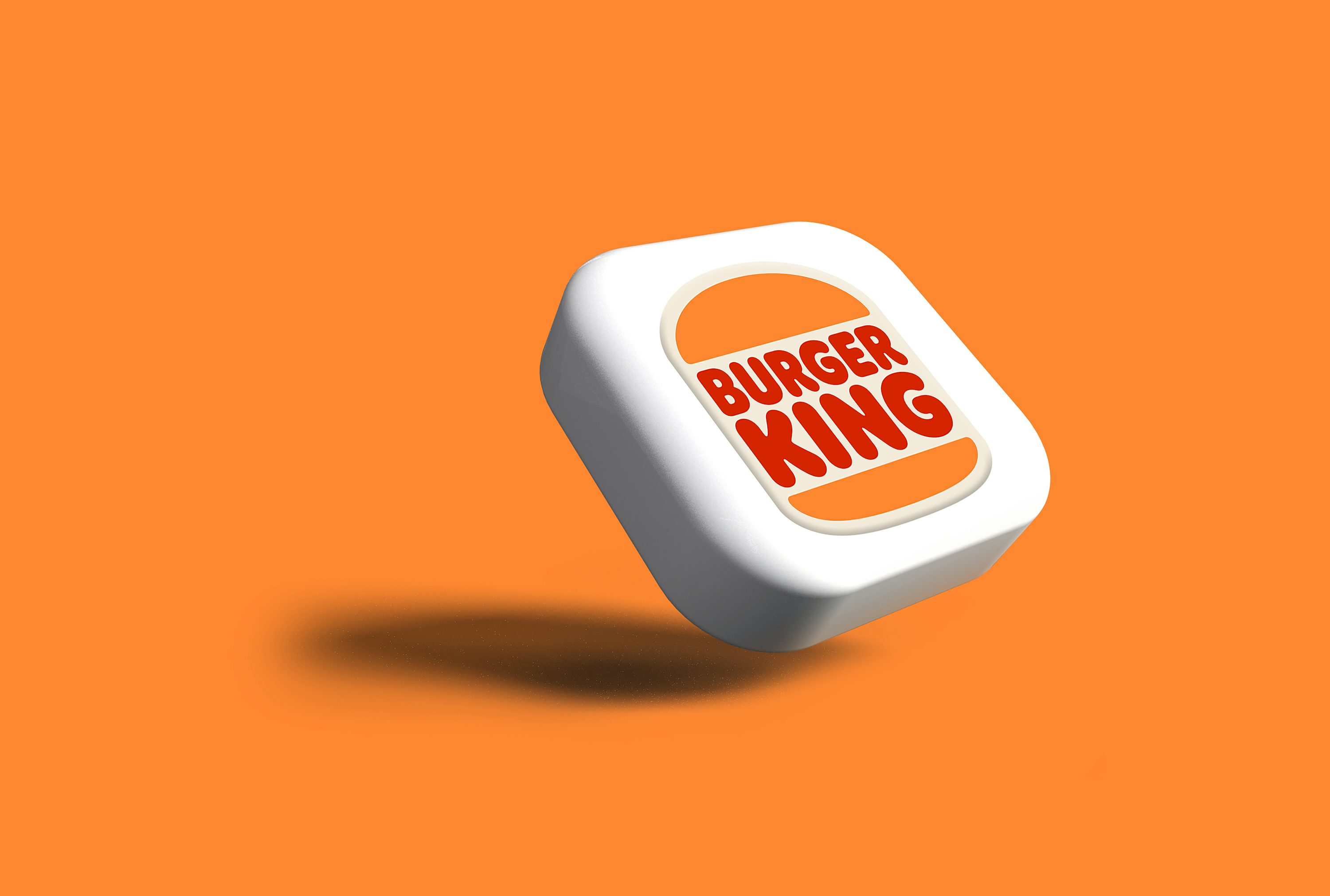 A burger king logo on an orange background photo