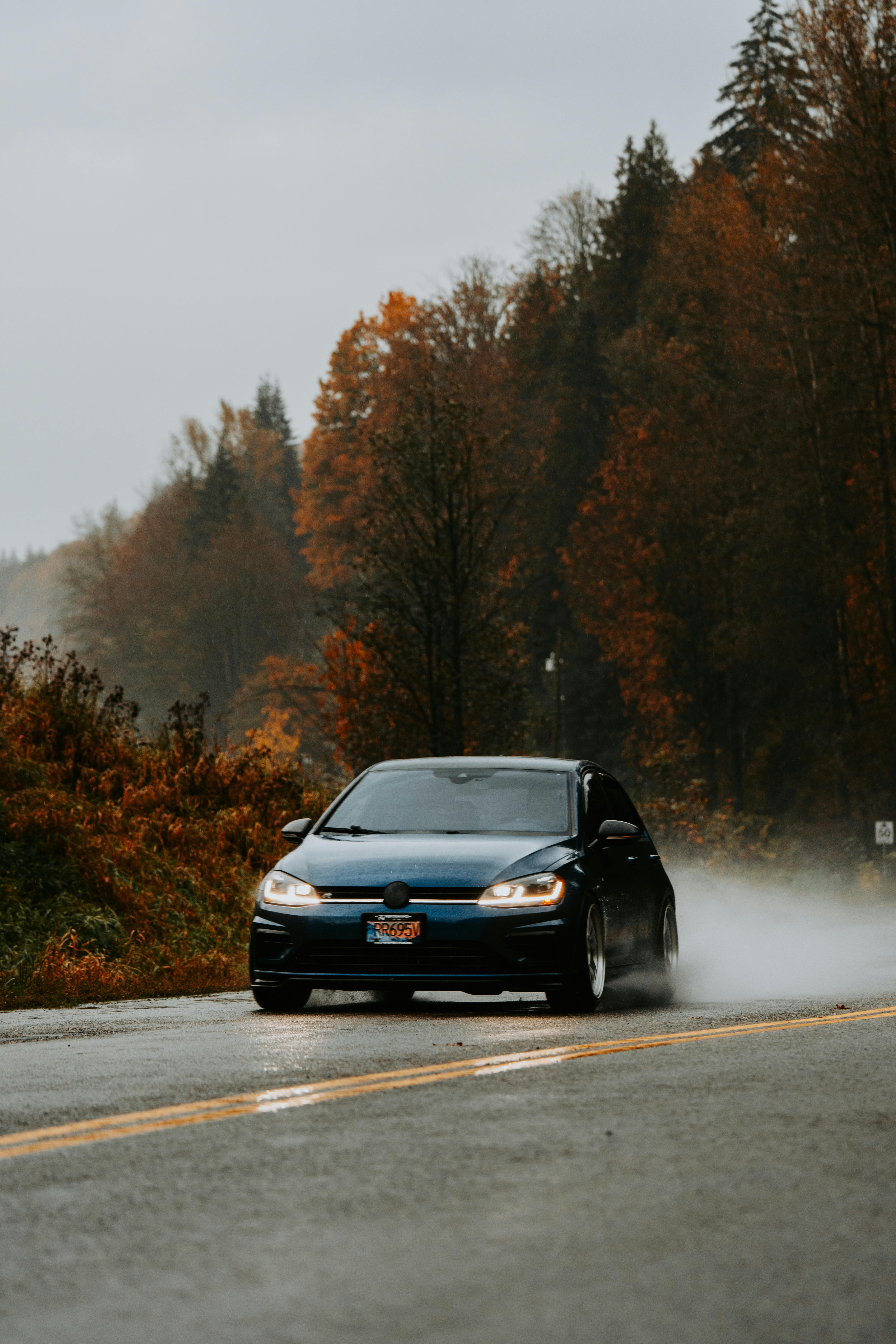 Black Car Driving on Wet Autumn Road · Free