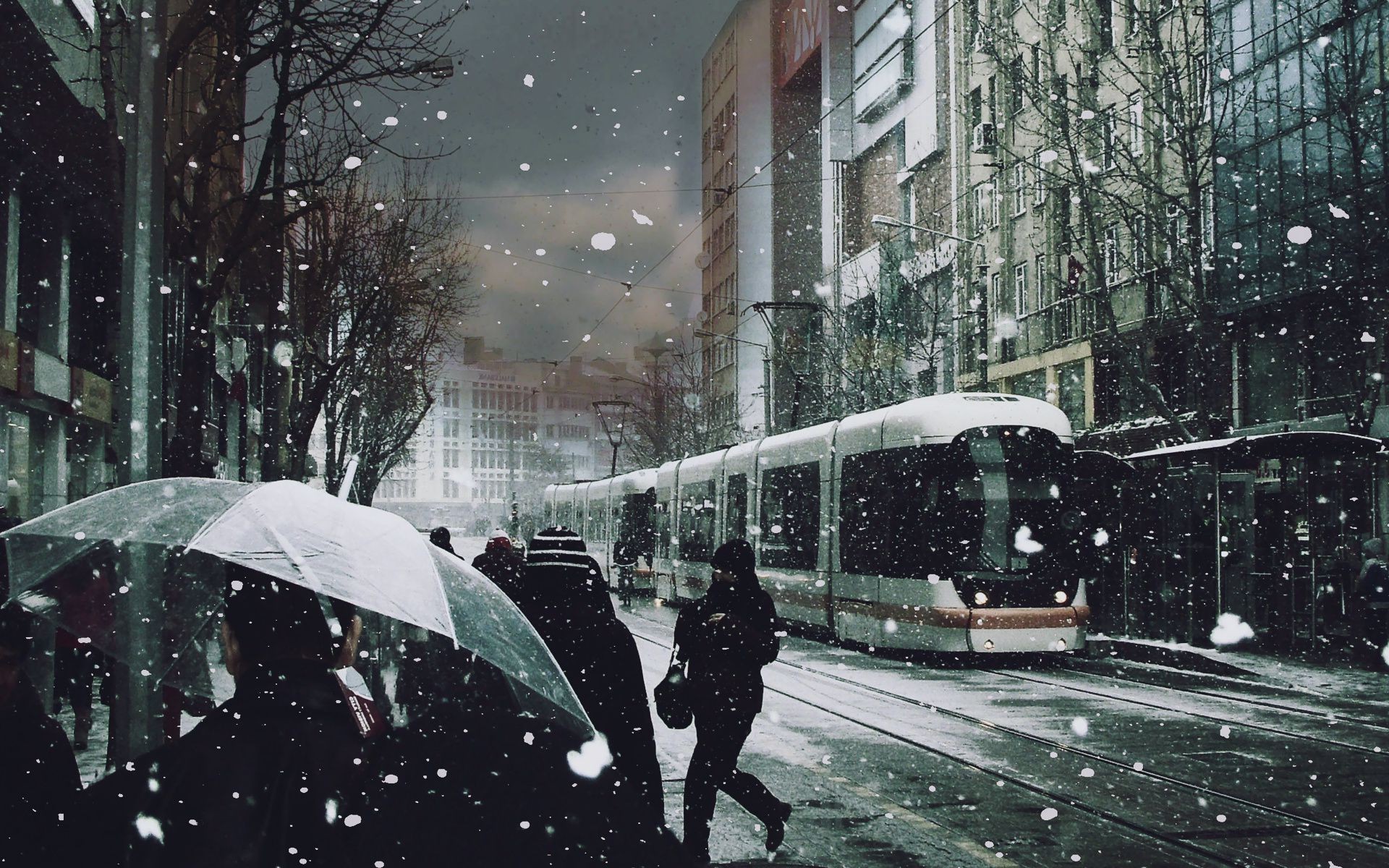 Tram and girl under sudden snow in the city