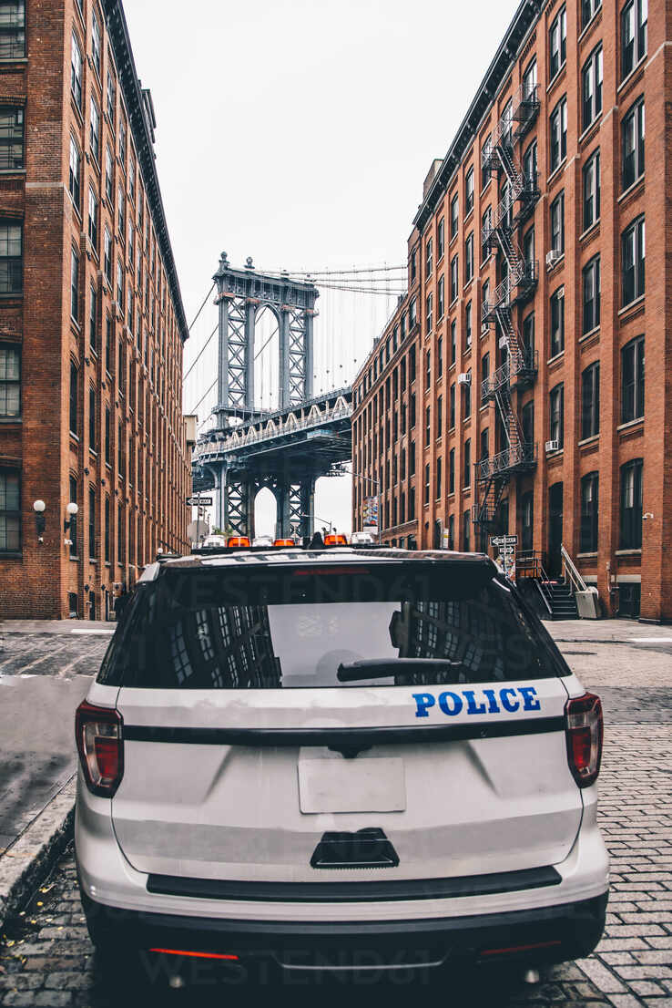 USA, New York, New York City, Police car on street with Manhattan Bridge in background