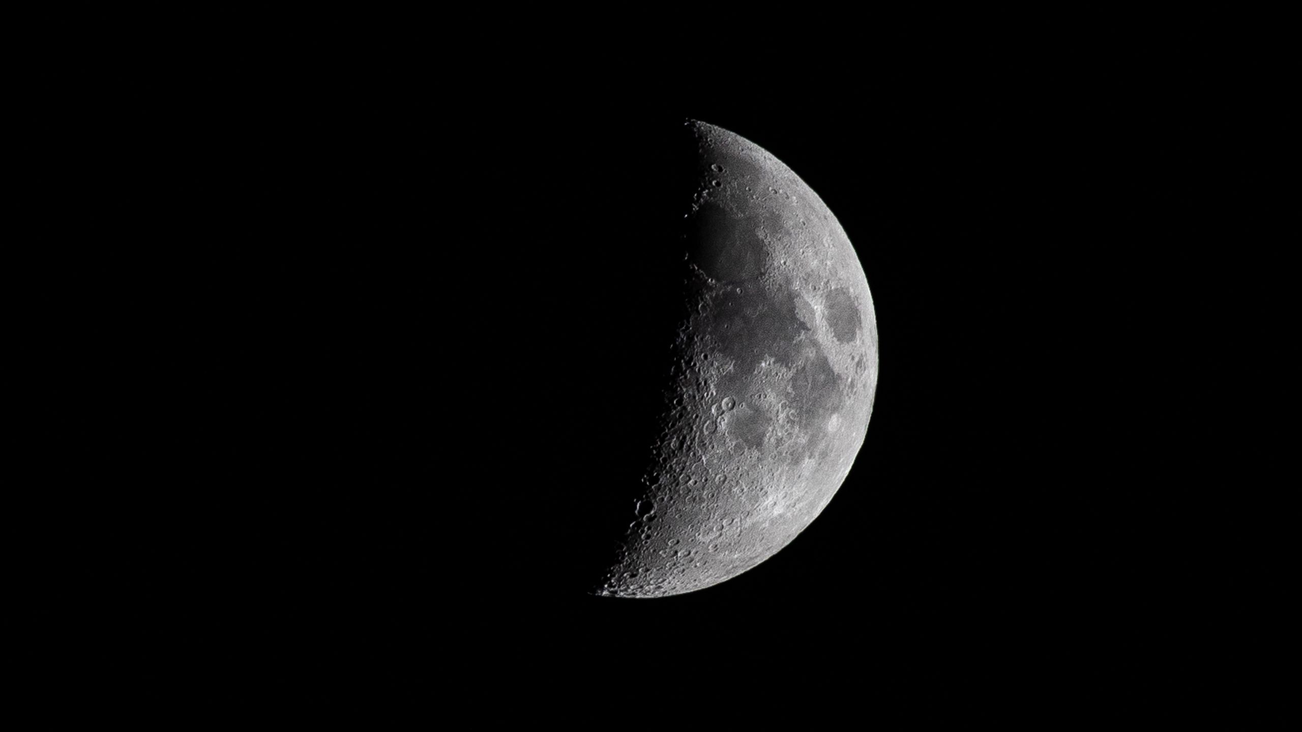 Download wallpaper 2560x1440 moon, craters, black, night, shadow widescreen 16:9 HD background