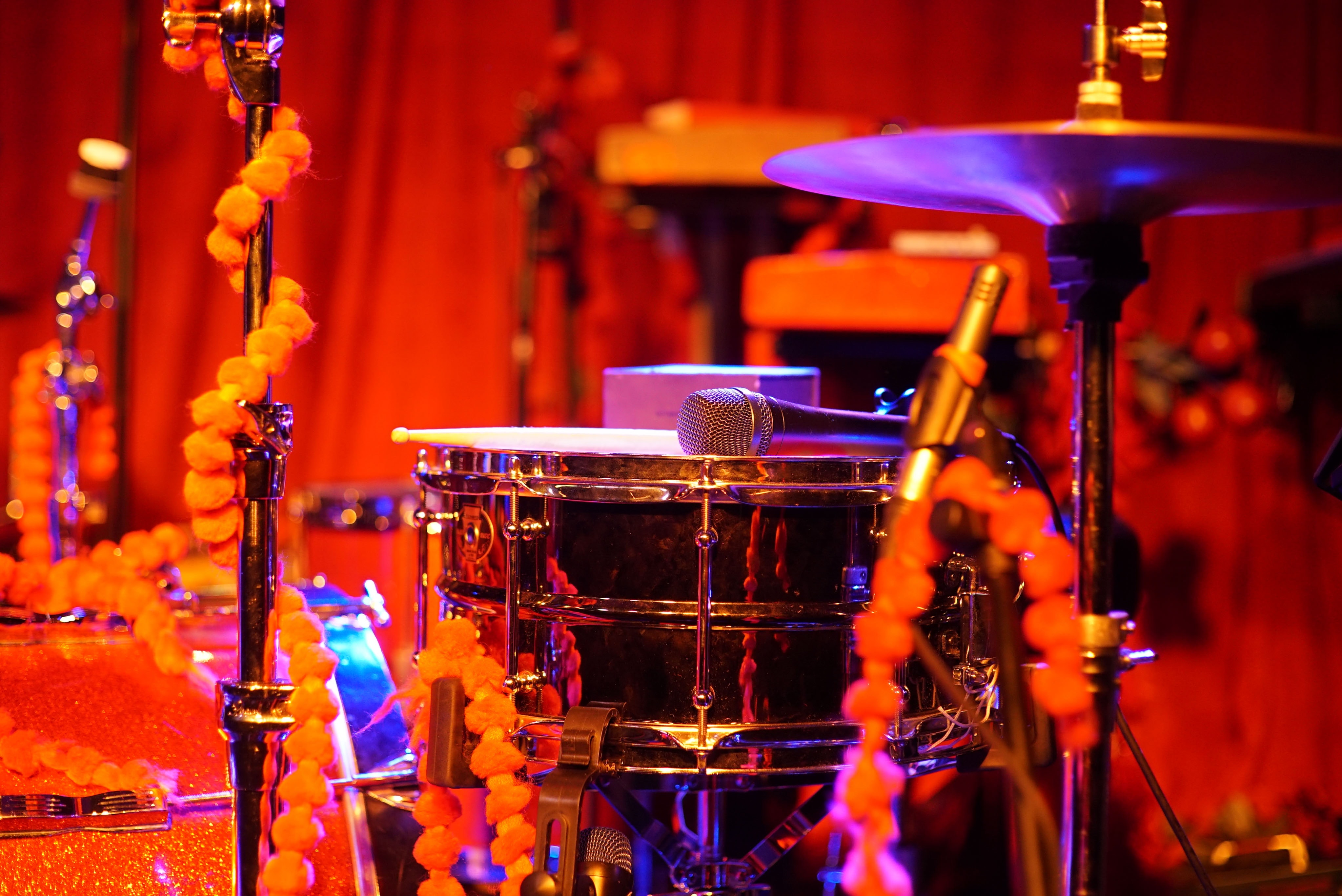 Free Image, drums, percussion, red, musician, musical instrument, lighting, percussionist, event, stage, drummer, tom tom drum, timbales, performing arts, music venue, Gong bass drum, Membranophone, musical instrument accessory, rock concert, performance