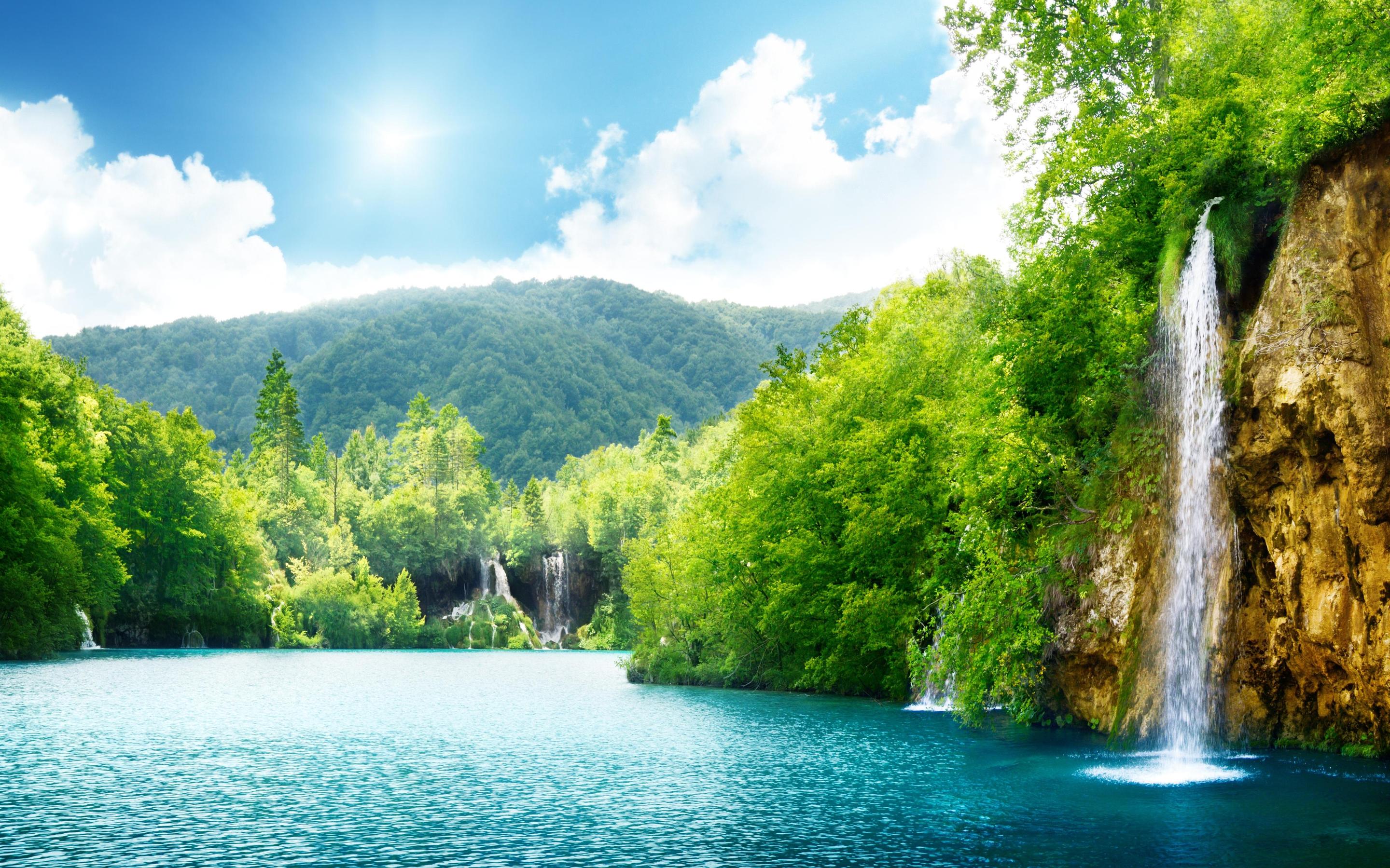 Summer sunny day and wonderful waterfall in the nature