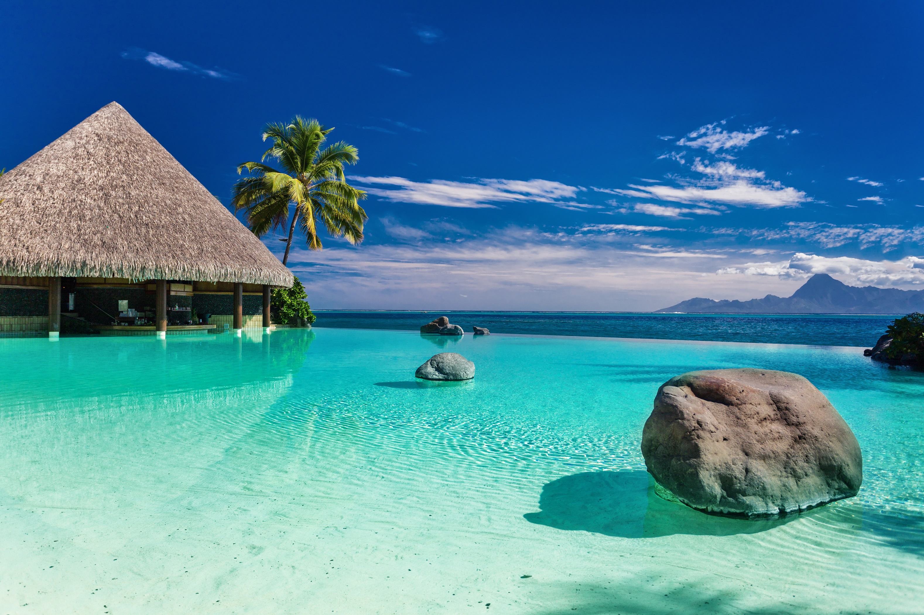 House in the water on a tropical beach under a blue sky in summer Desktop wallpaper 1600x900