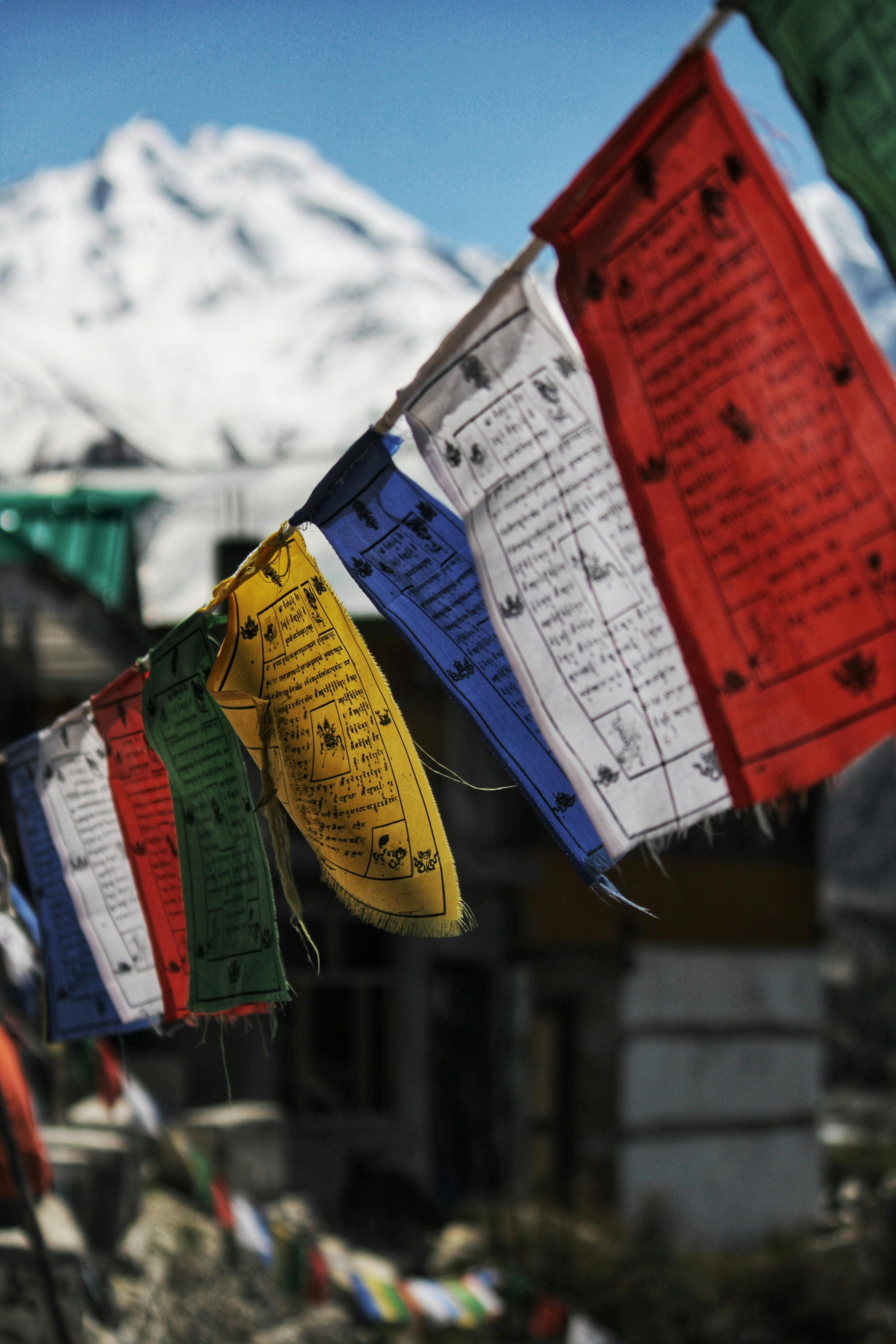 Colourful Buddhist Prayer Flags and Snowed Mountain in Background · Free
