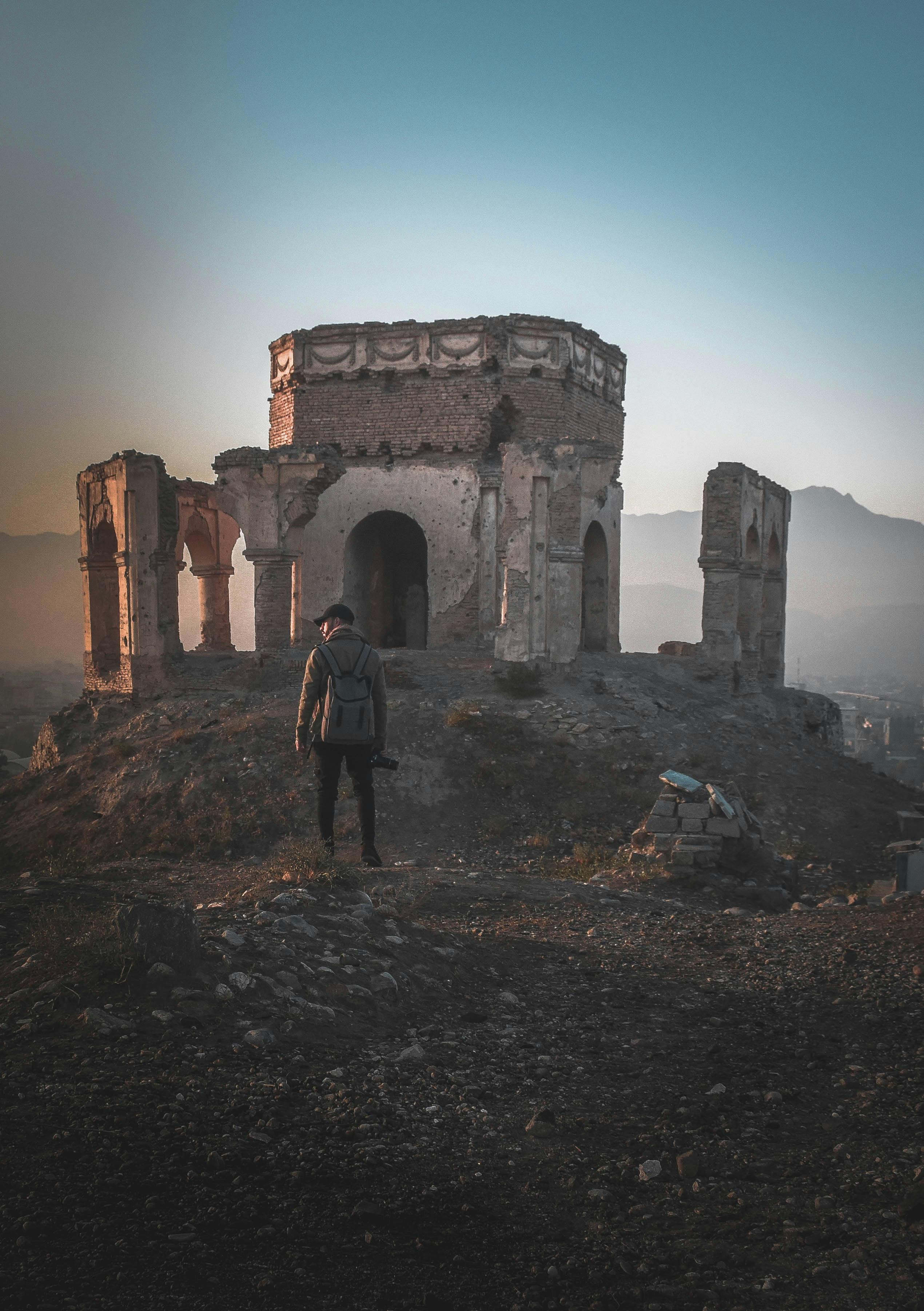 Man Standing on Ruins Digital Wallpaper · Free