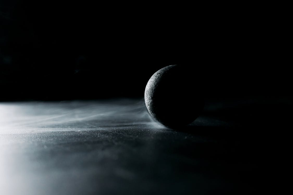 A Black Ball on Black Surface · Free