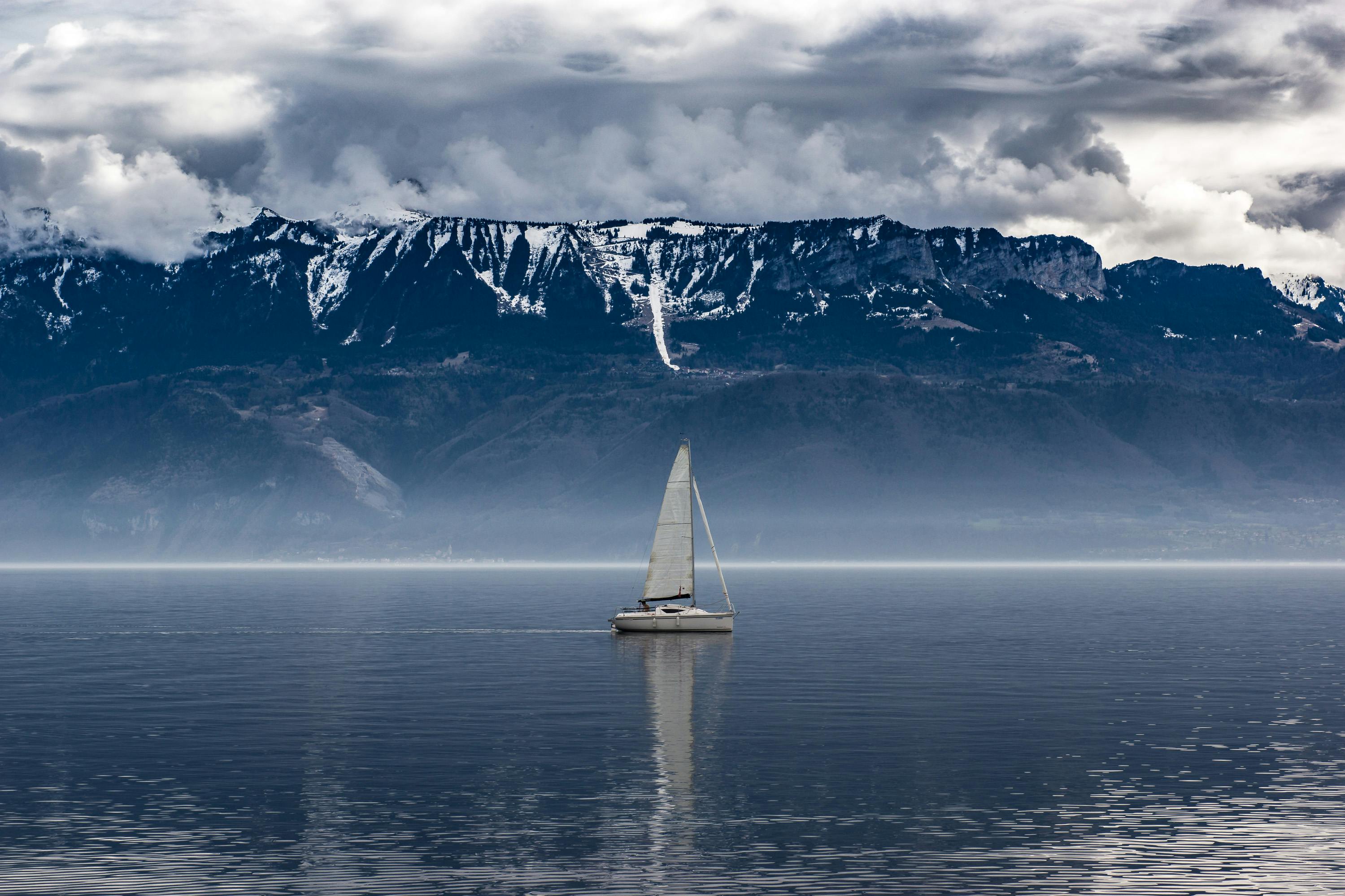 White Sailboat on Body of Water Near Mountain · Free