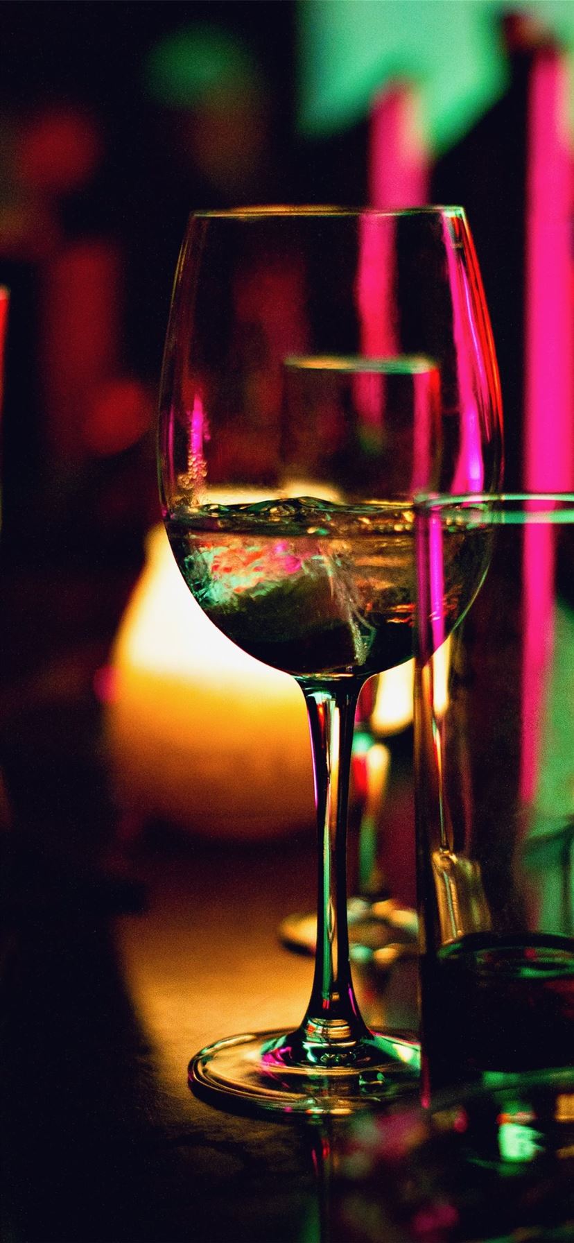 half filled wine glass beside half empty clear pin. iPhone 11 Wallpaper Free Download