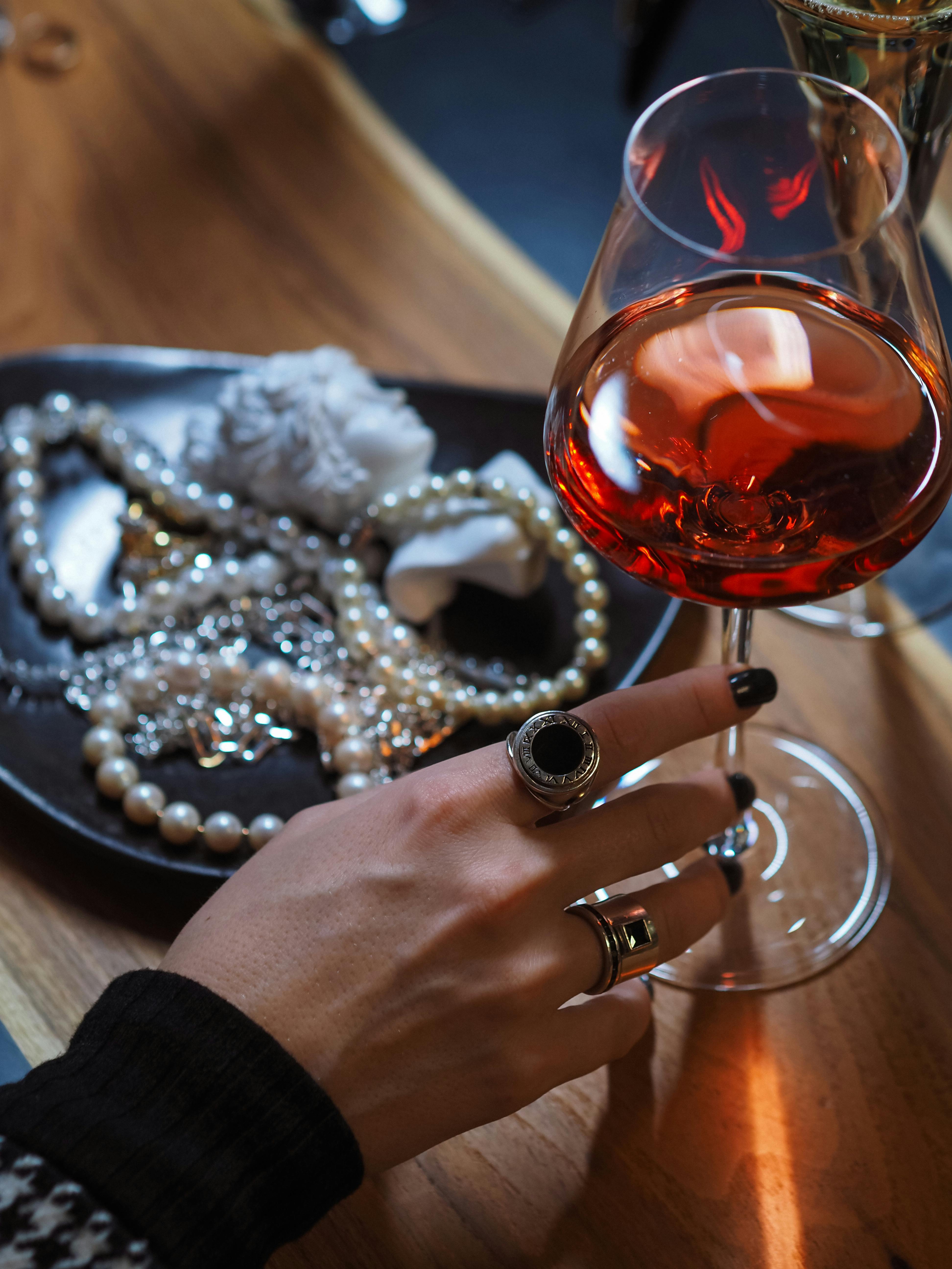 Person Holding Holding a Glass of Red Wine · Free