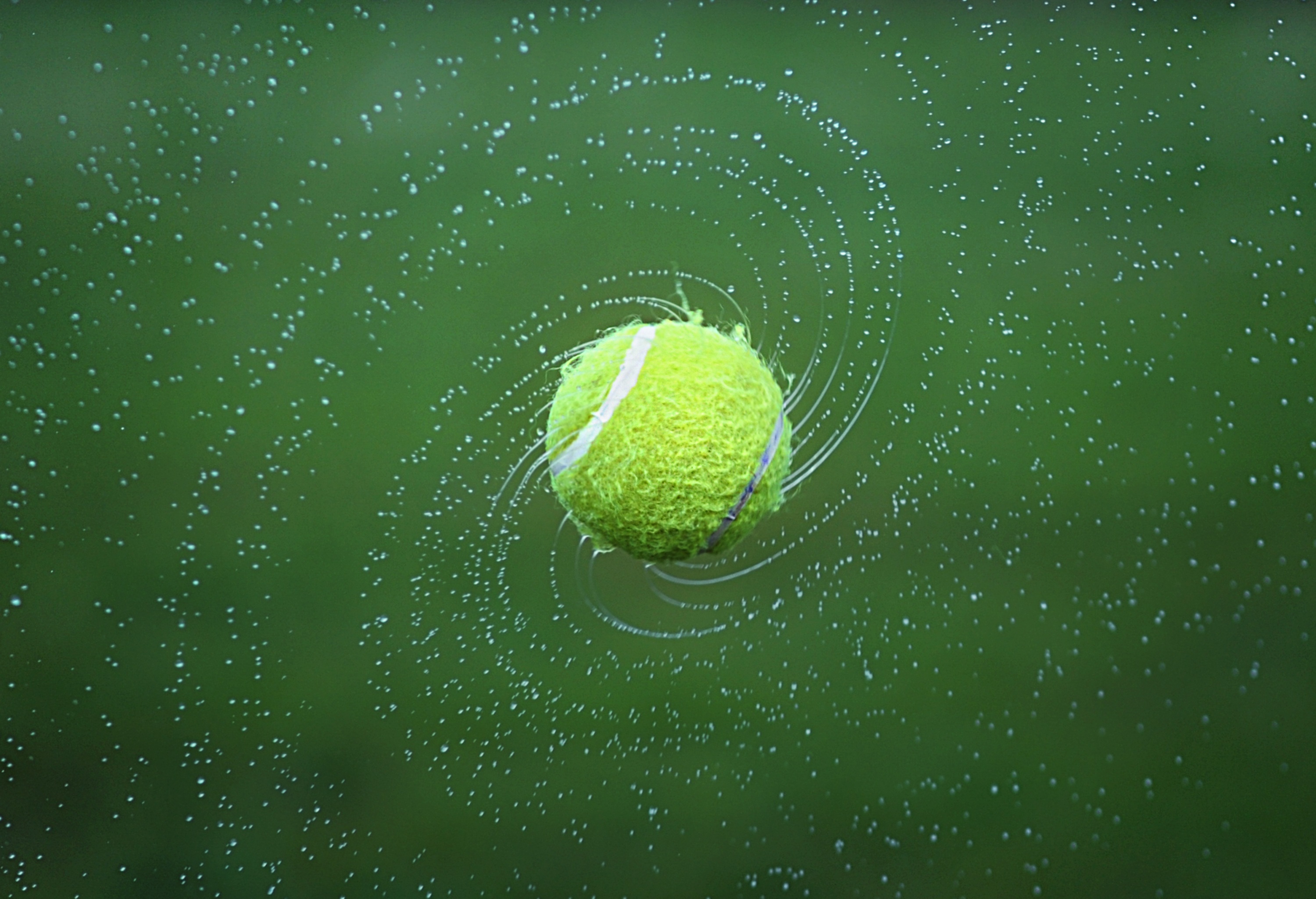 Tennis ball in splashing water on green background Desktop wallpaper 1152x864