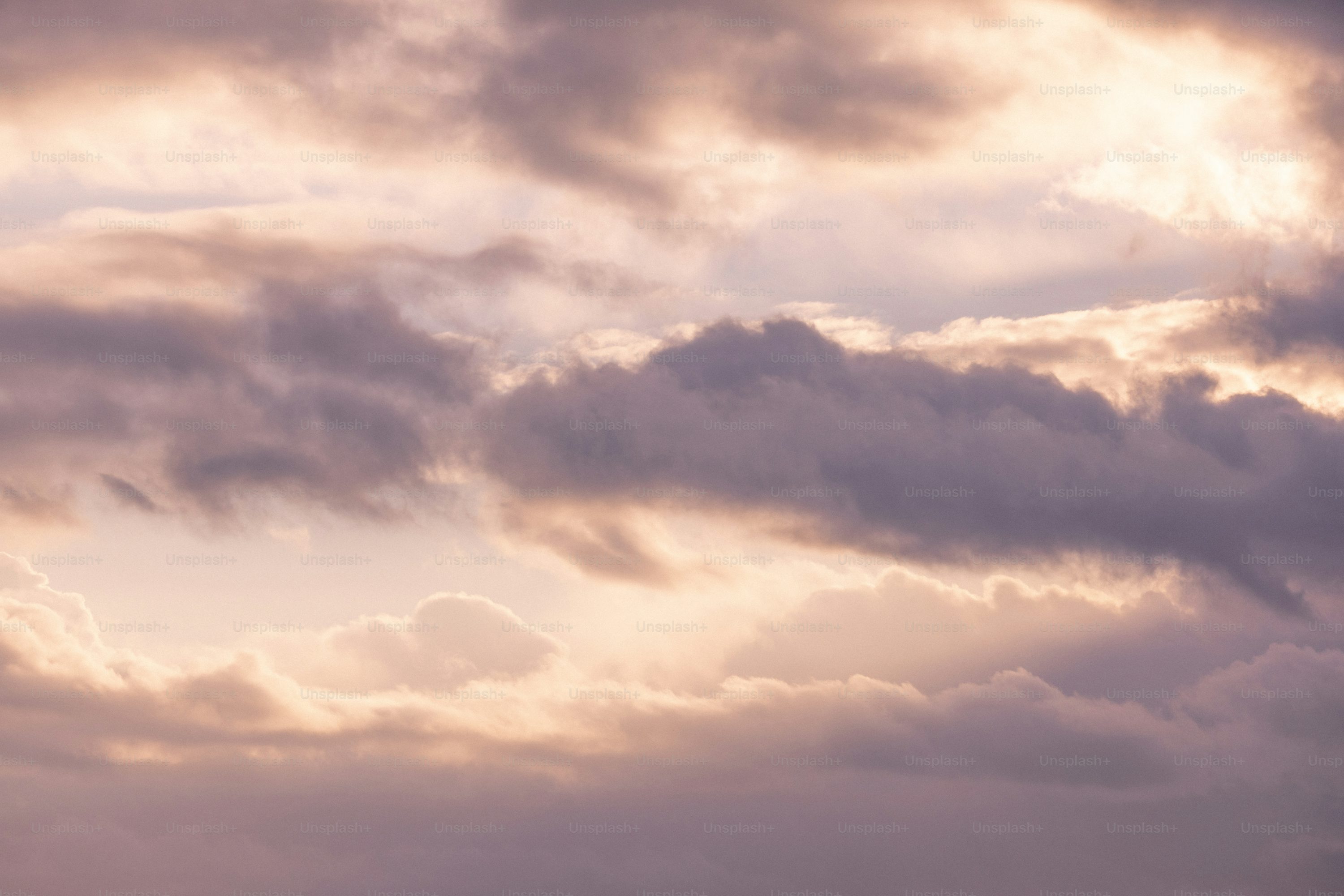 A plane flying through a cloudy sky photo