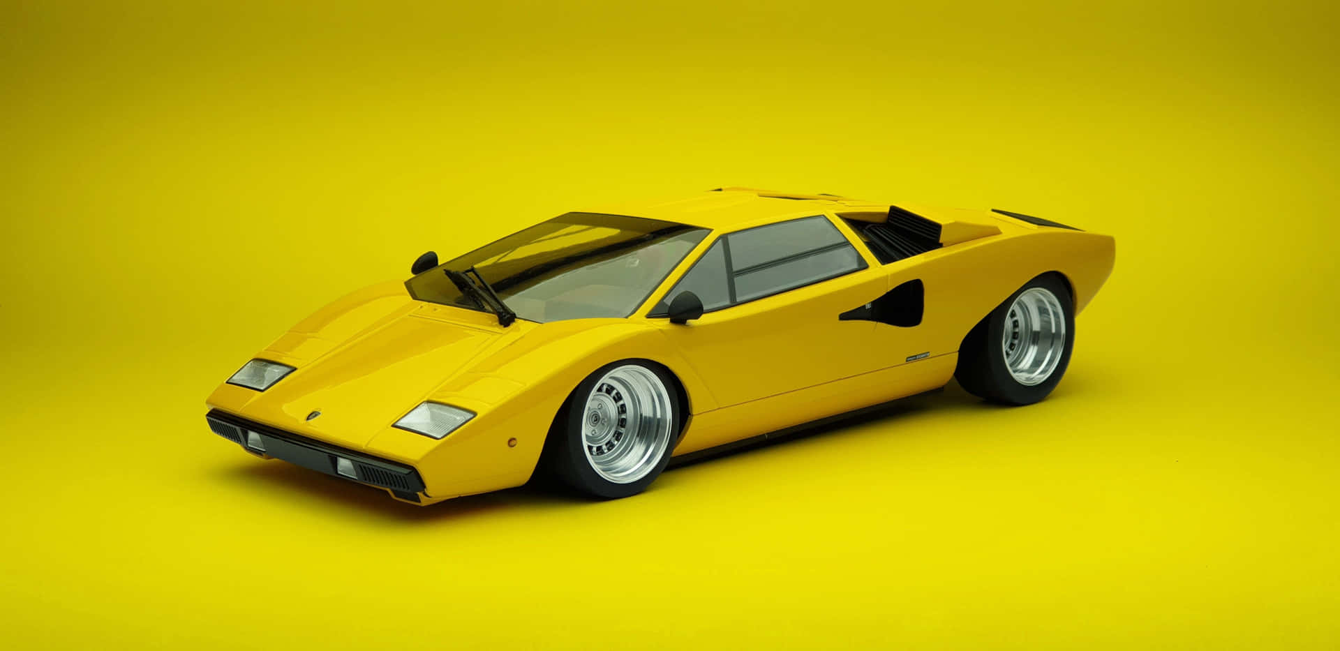 Download A classic Lamborghini Countach on the road. Iconic luxury sports car that surpasses time. Wallpaper