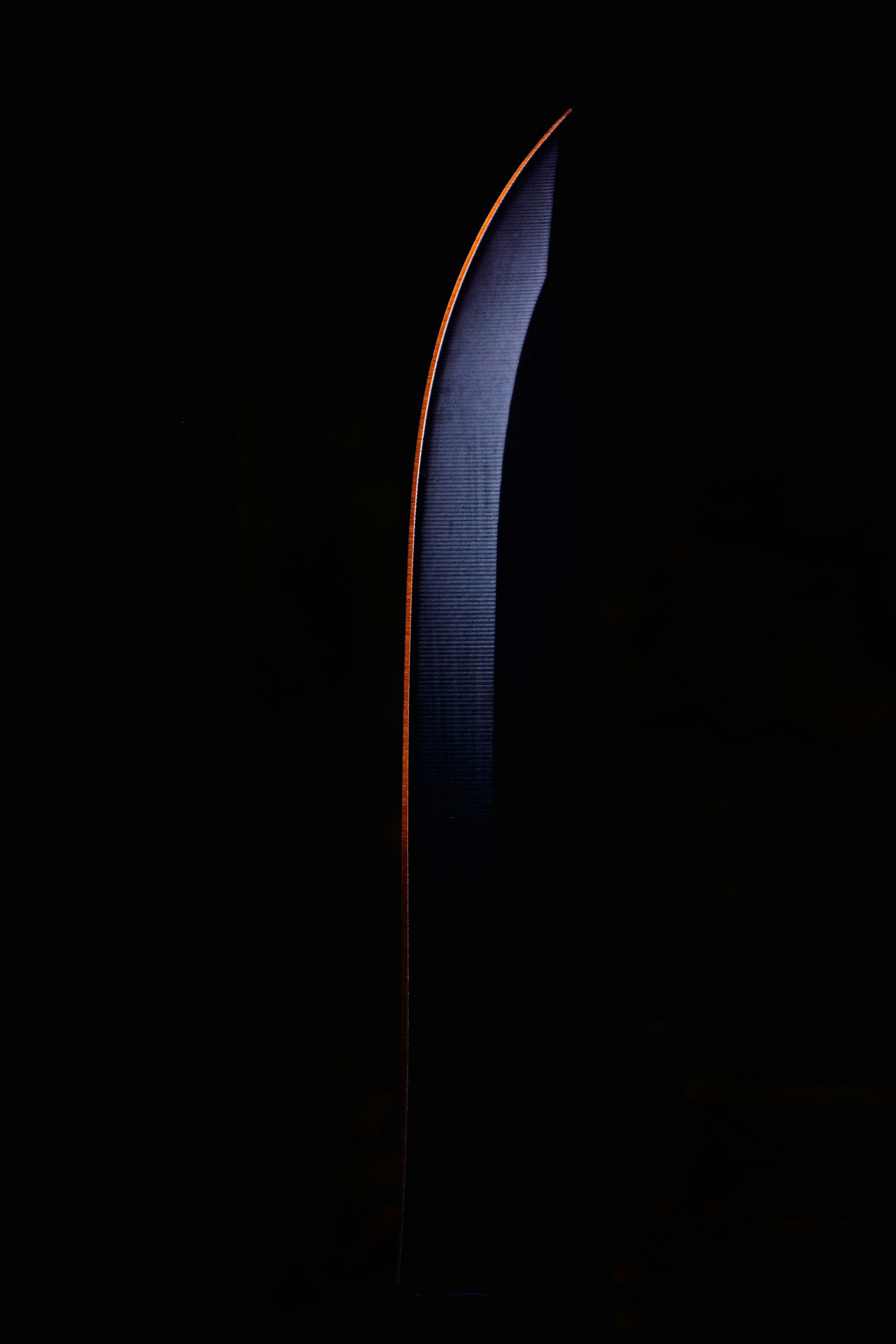 A large knife in the dark with a black background photo