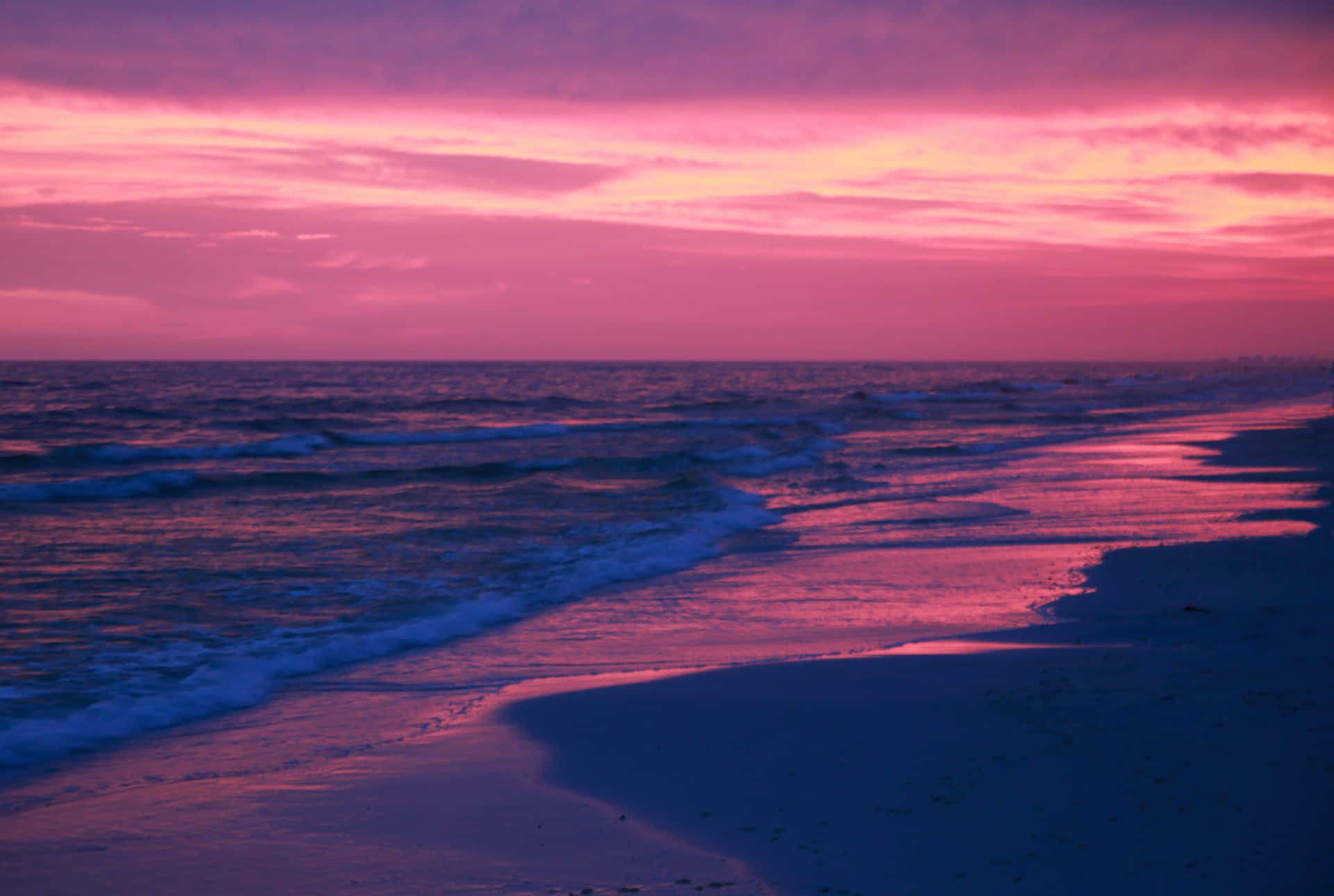 Download Pink Beach Sunset With An Empty Beach Wallpaper