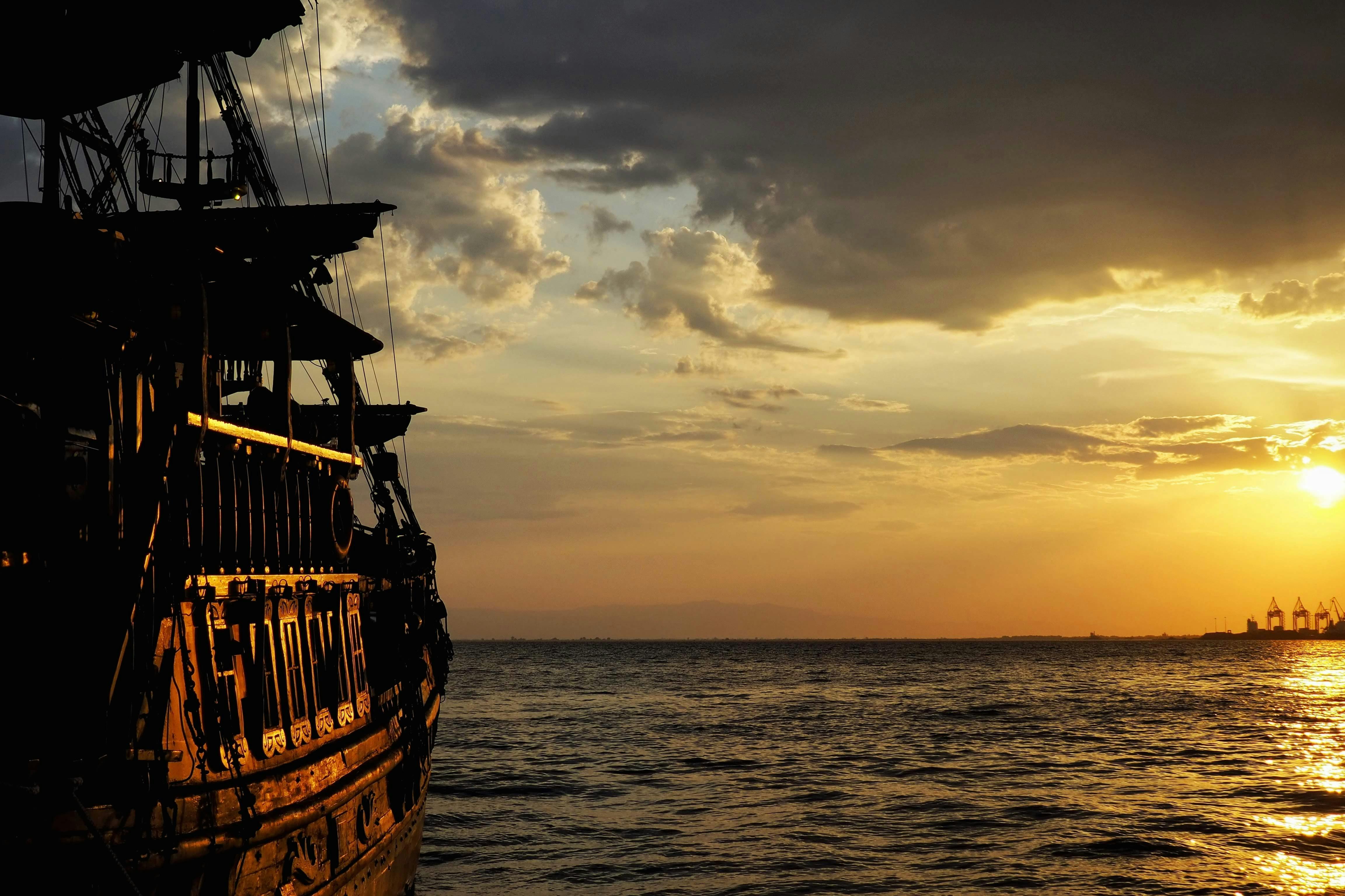 A Ship Sailing on the Sea During Sunset · Free