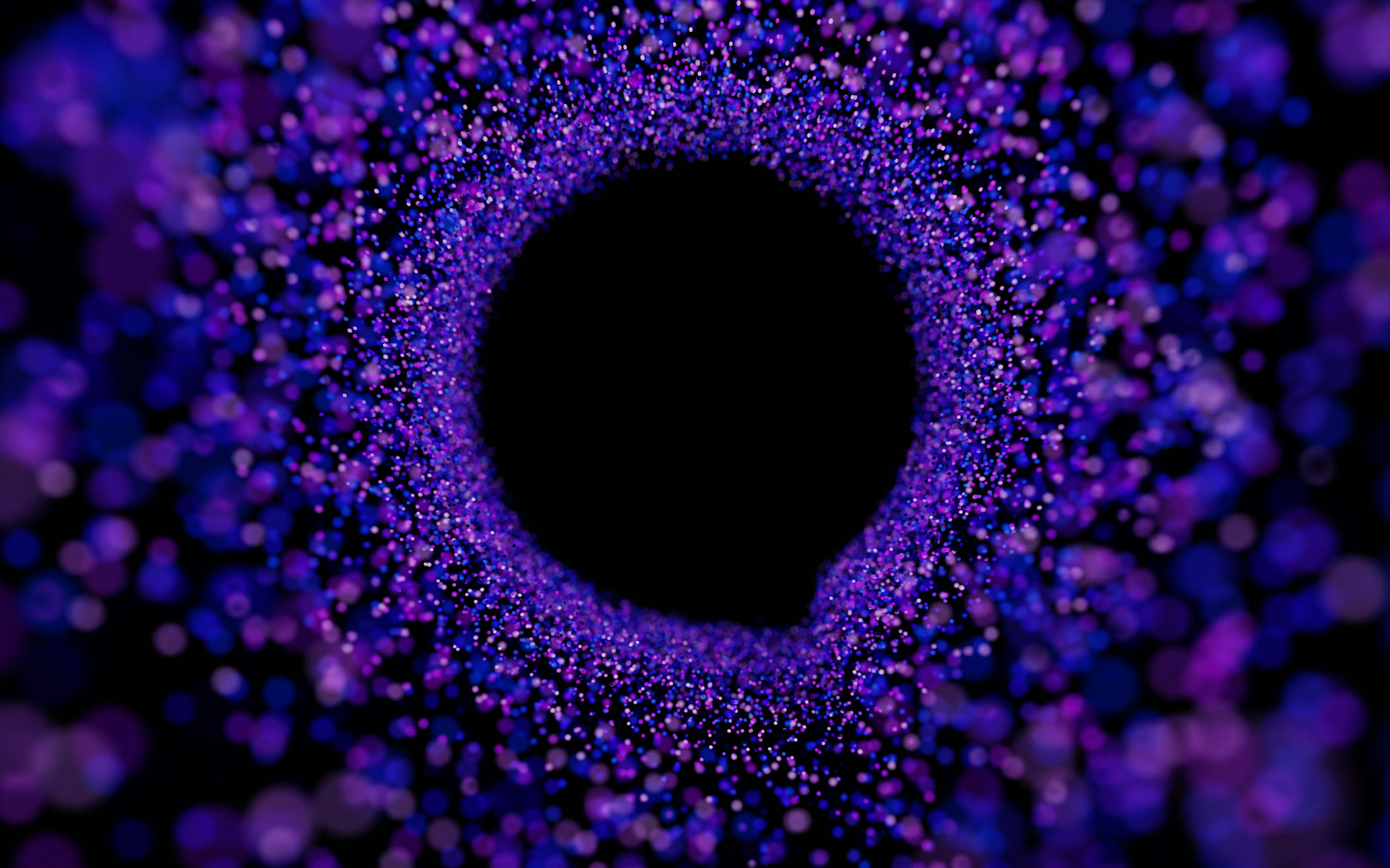 A black hole in the center of a purple background photo