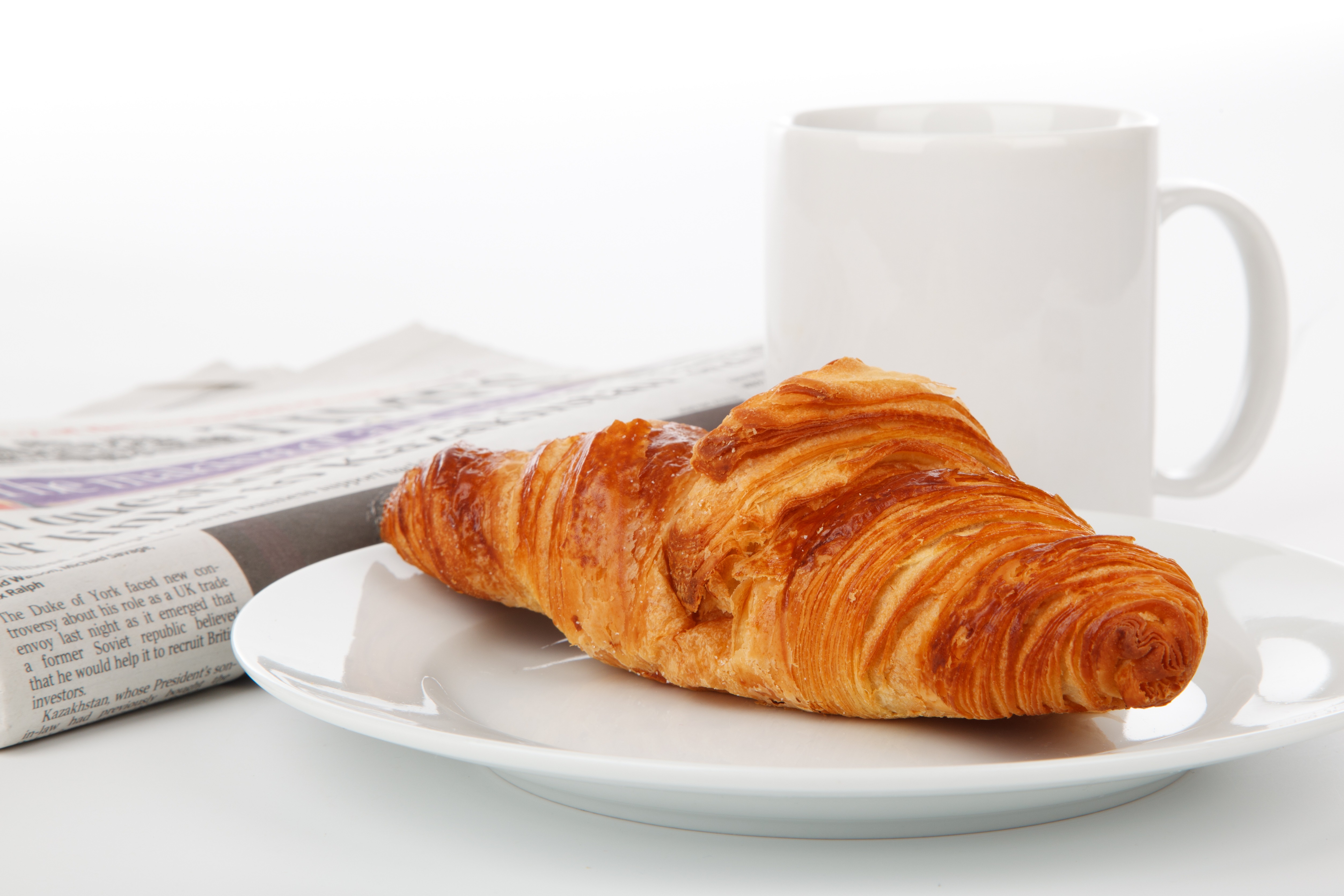 Fresh croissant lies on a white plate with coffee Desktop wallpaper 1024x1024