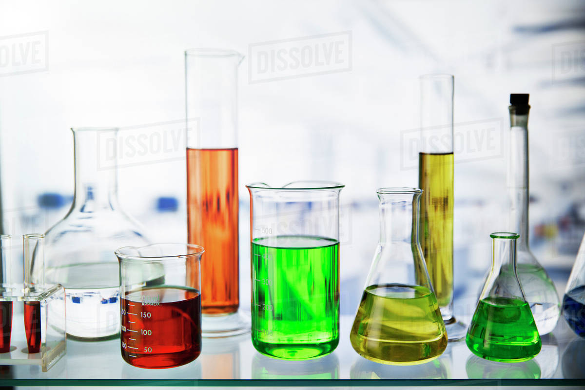 Beakers Of Various Solutions On Shelf In Lab Free
