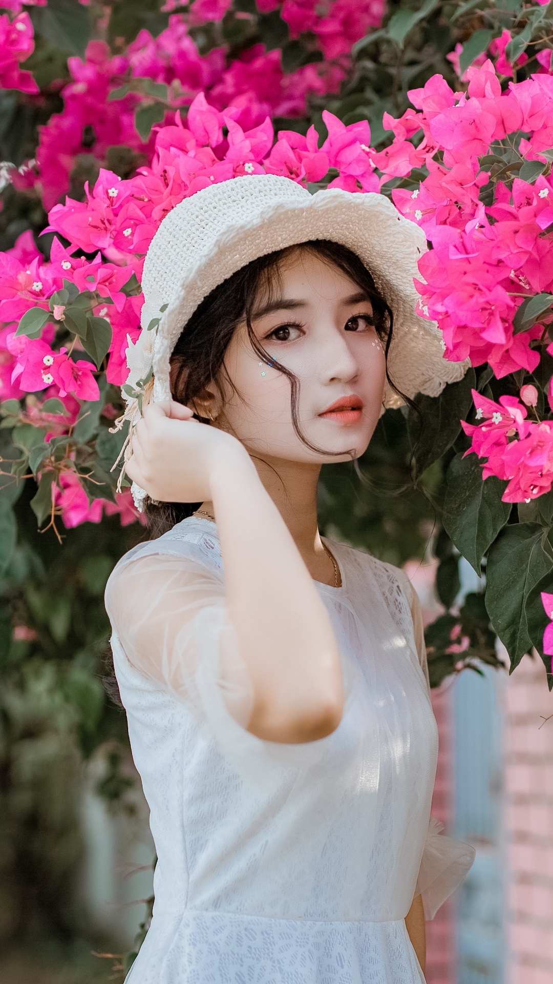 Beautiful Asian women pink flowers background Mobile Walls