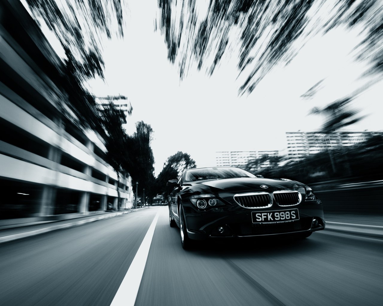 Black and white car in motion on the road