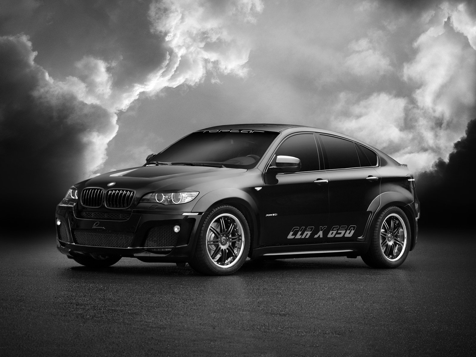 Black and white photo of a BMW on a background of clouds for your phone