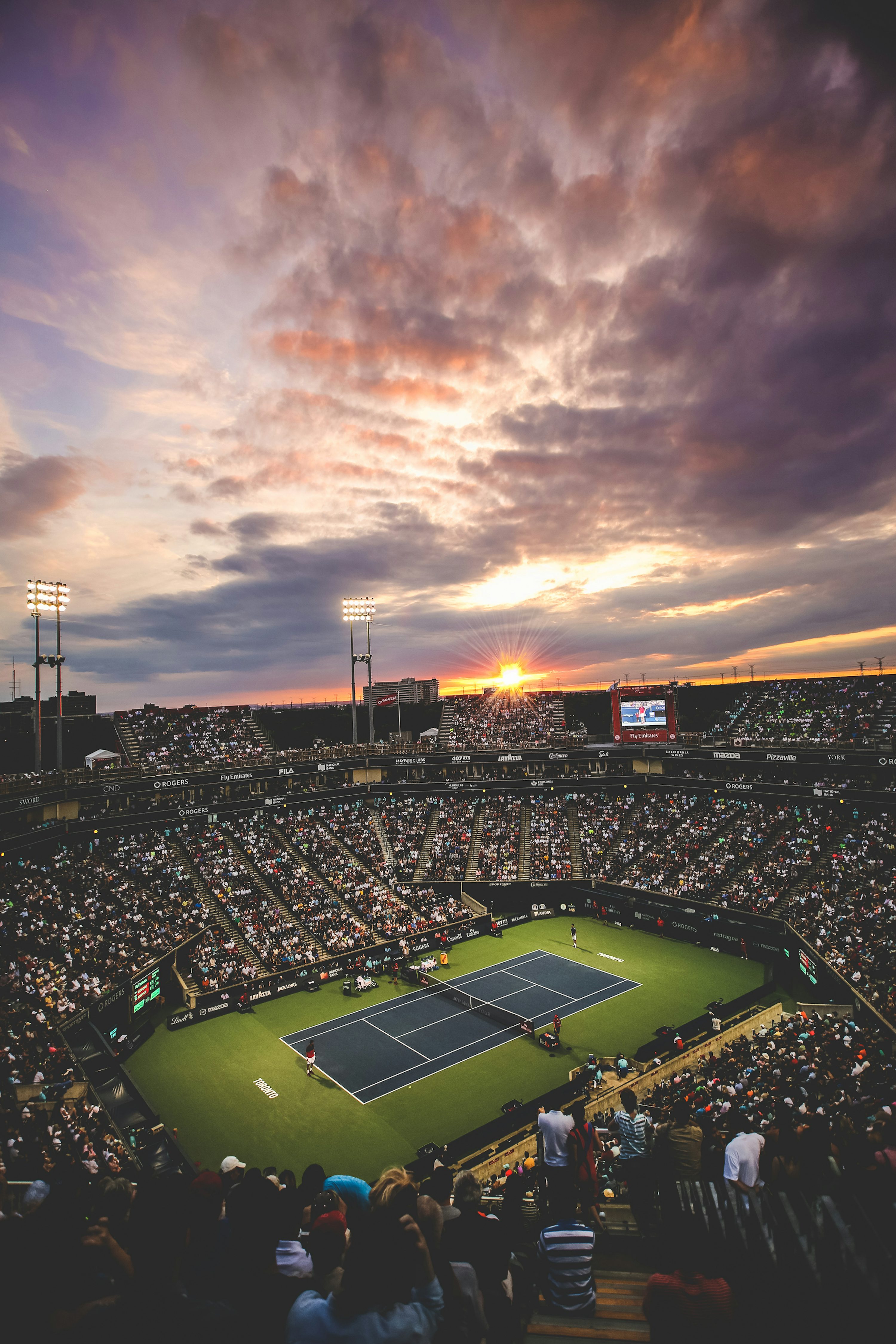 People at the tennis court stadium during sunset photo