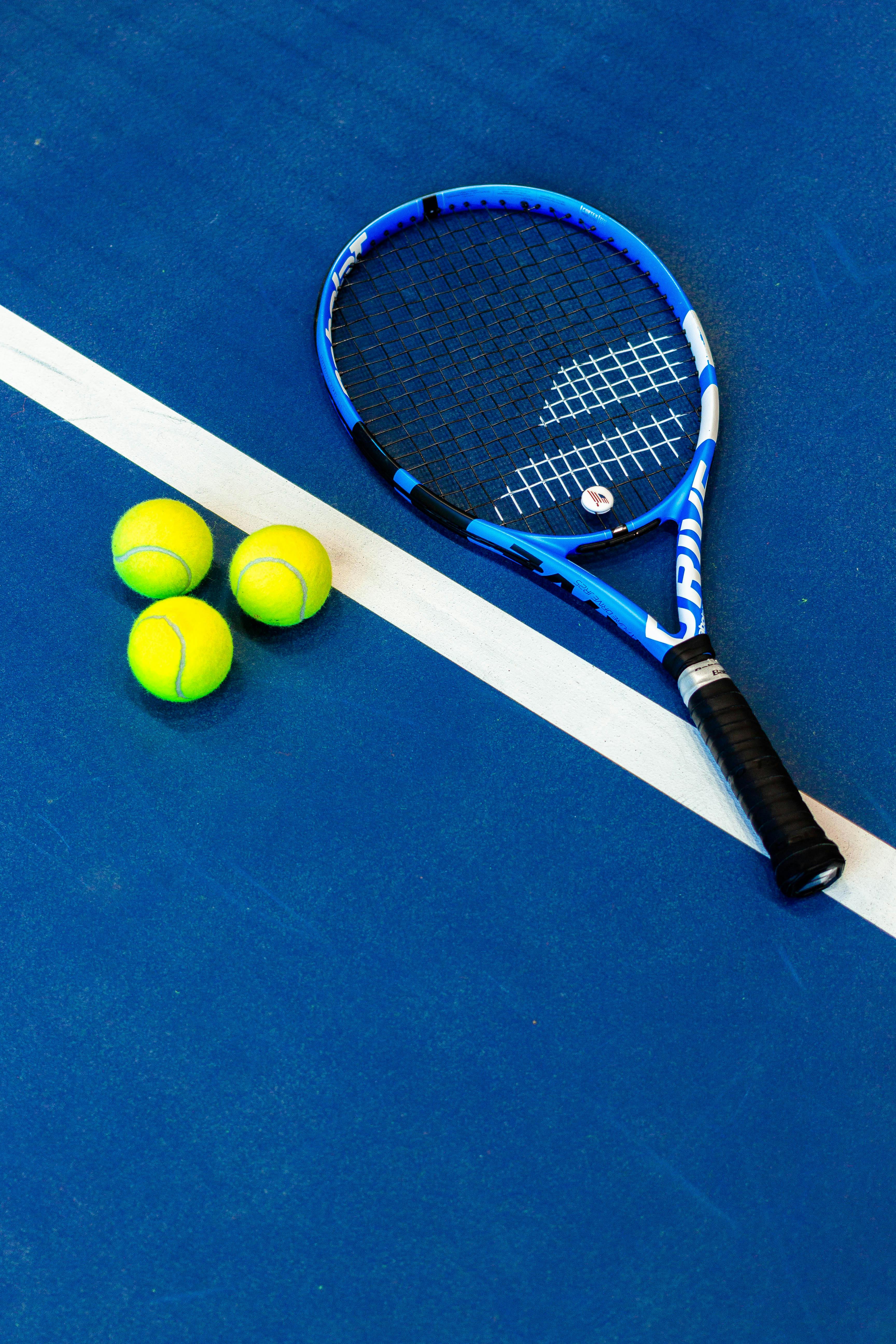 Blue Tennis Racket on the Ground · Free