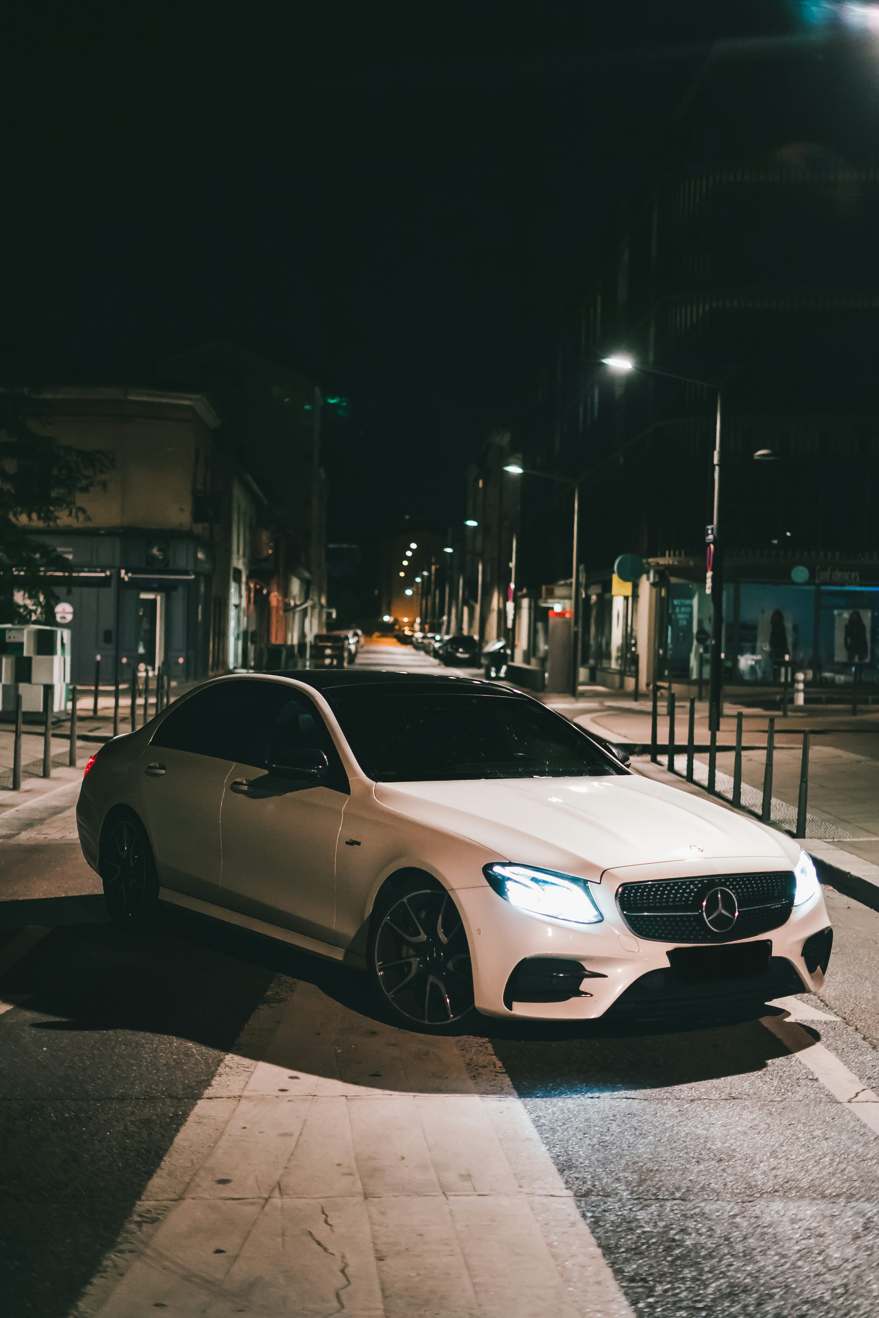 White mercedes benz coupe on road during night time photo