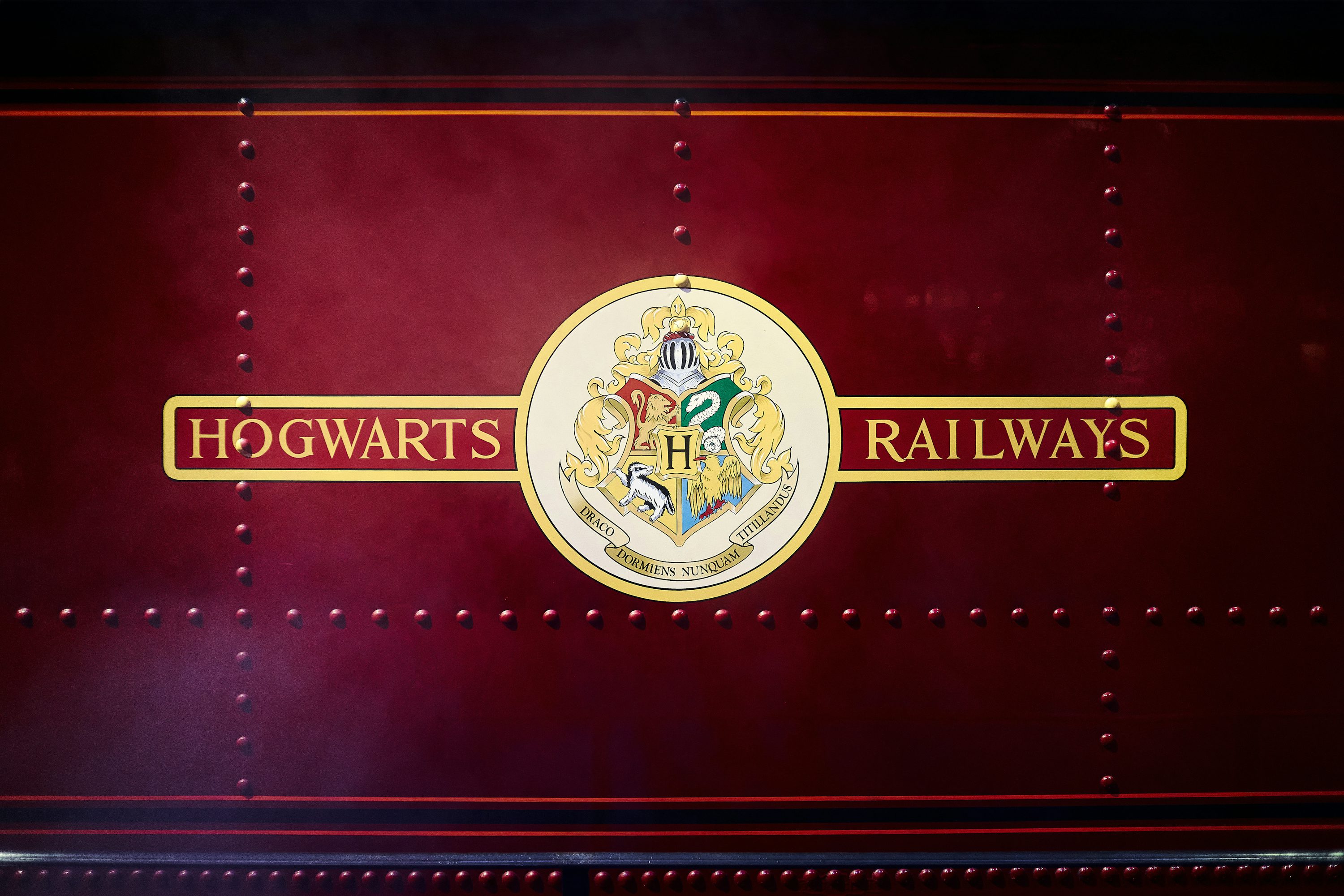 The hogwarts railway logo on the side of a train photo