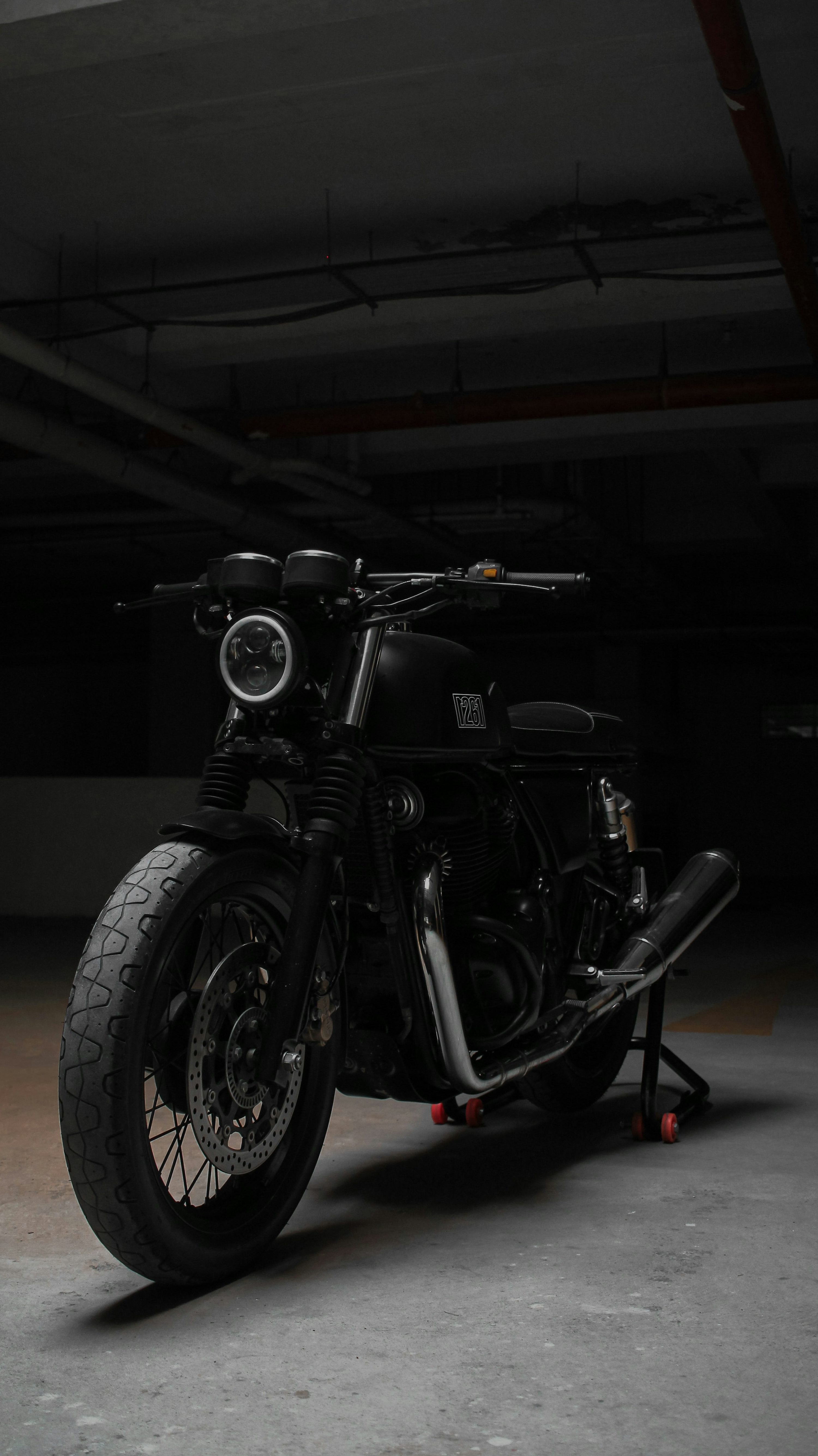 A black motorcycle parked in a parking garage photo