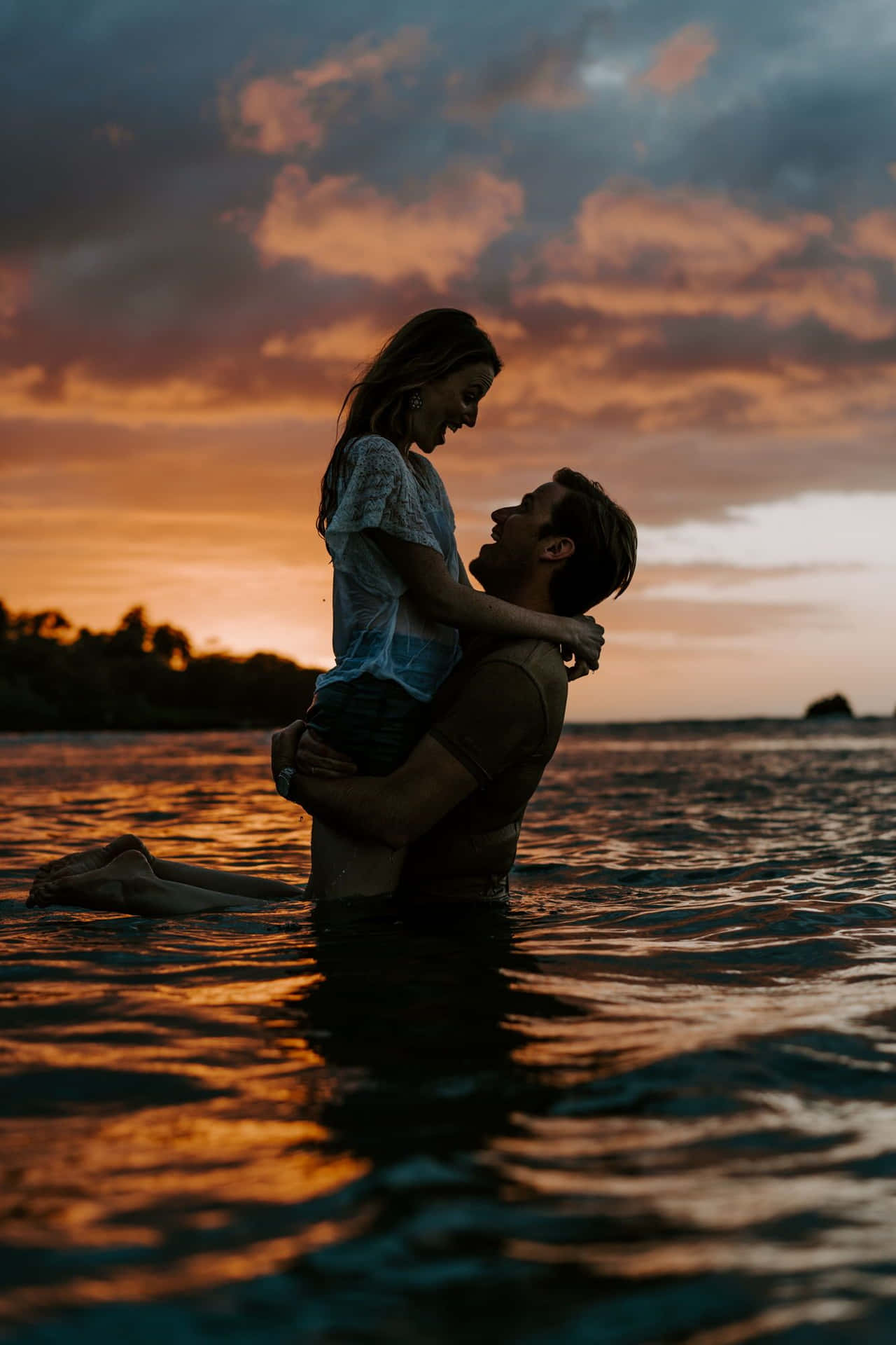Download A Romantic Sunset Embraced By Two Lovers