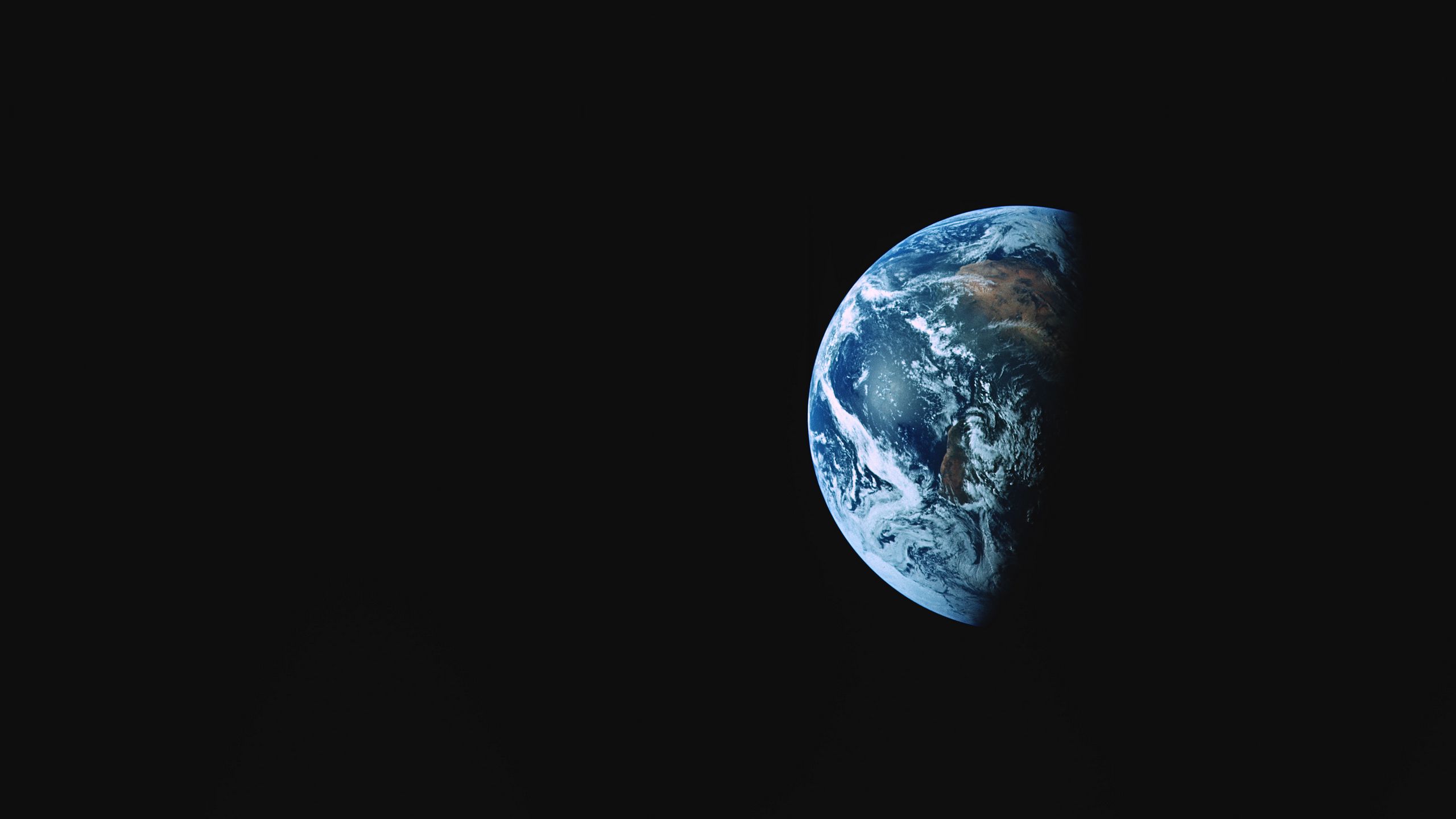 Download wallpaper 2560x1440 earth, planet, shadow, dark, space widescreen 16:9 HD background