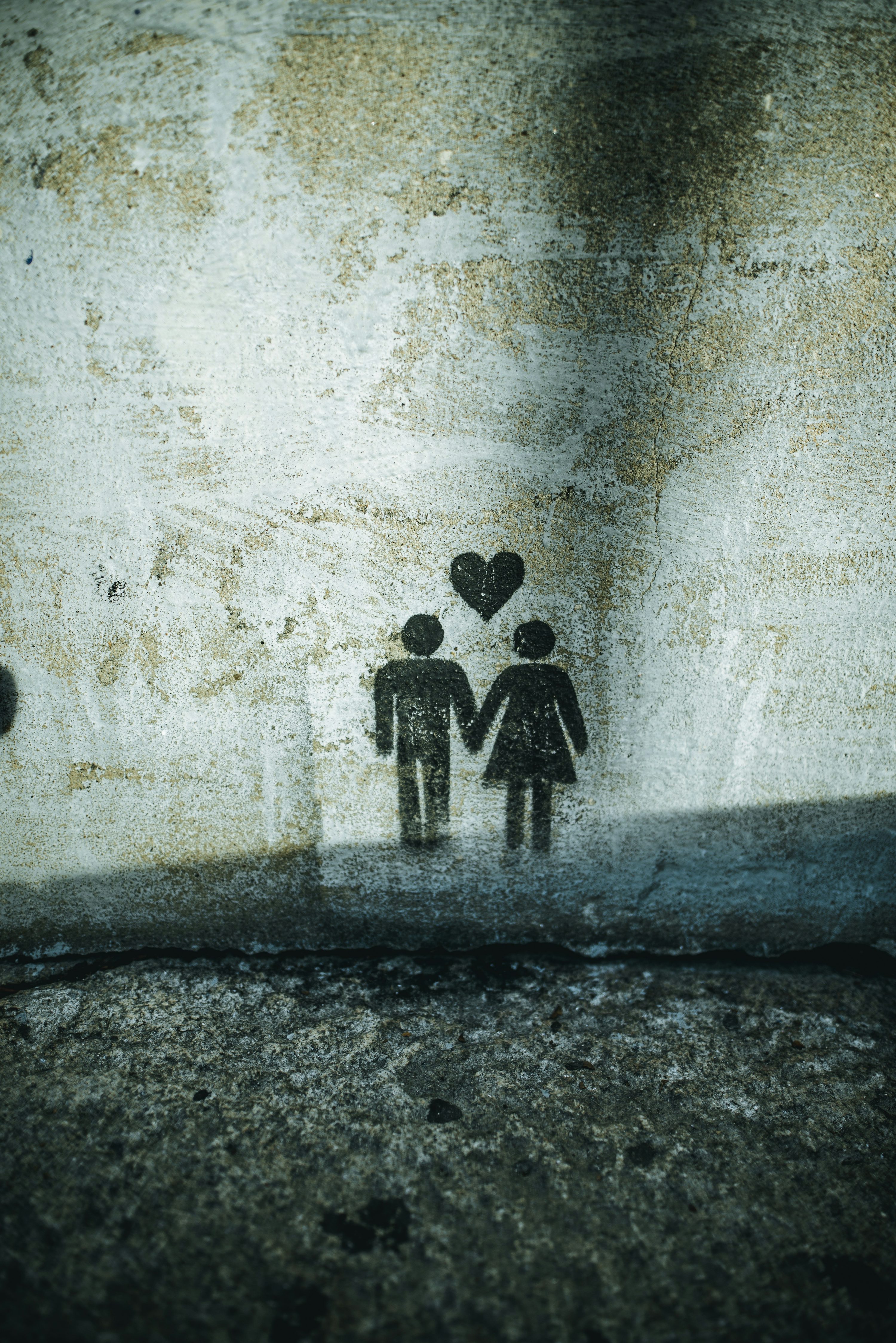 Couple holding hands painting on wall photo
