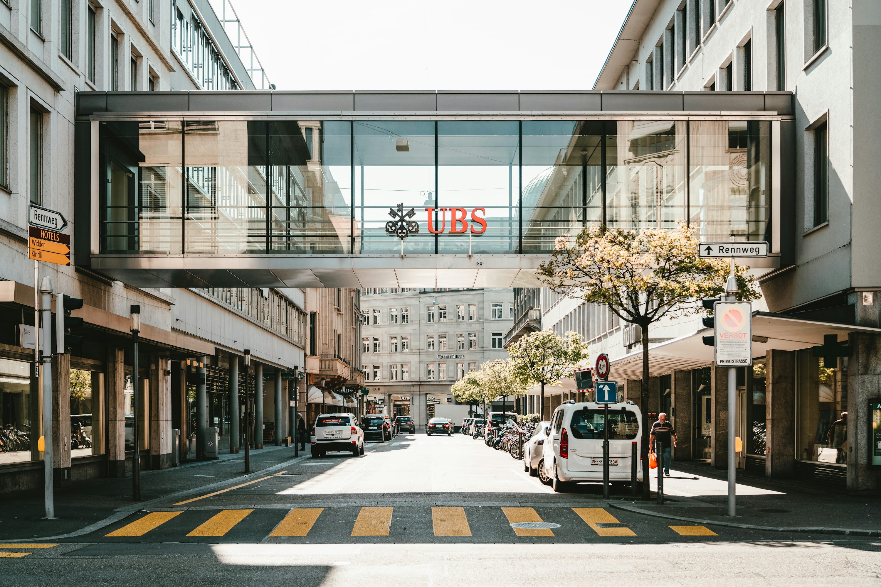 UBS logo on glass bridge wall during daytime photo