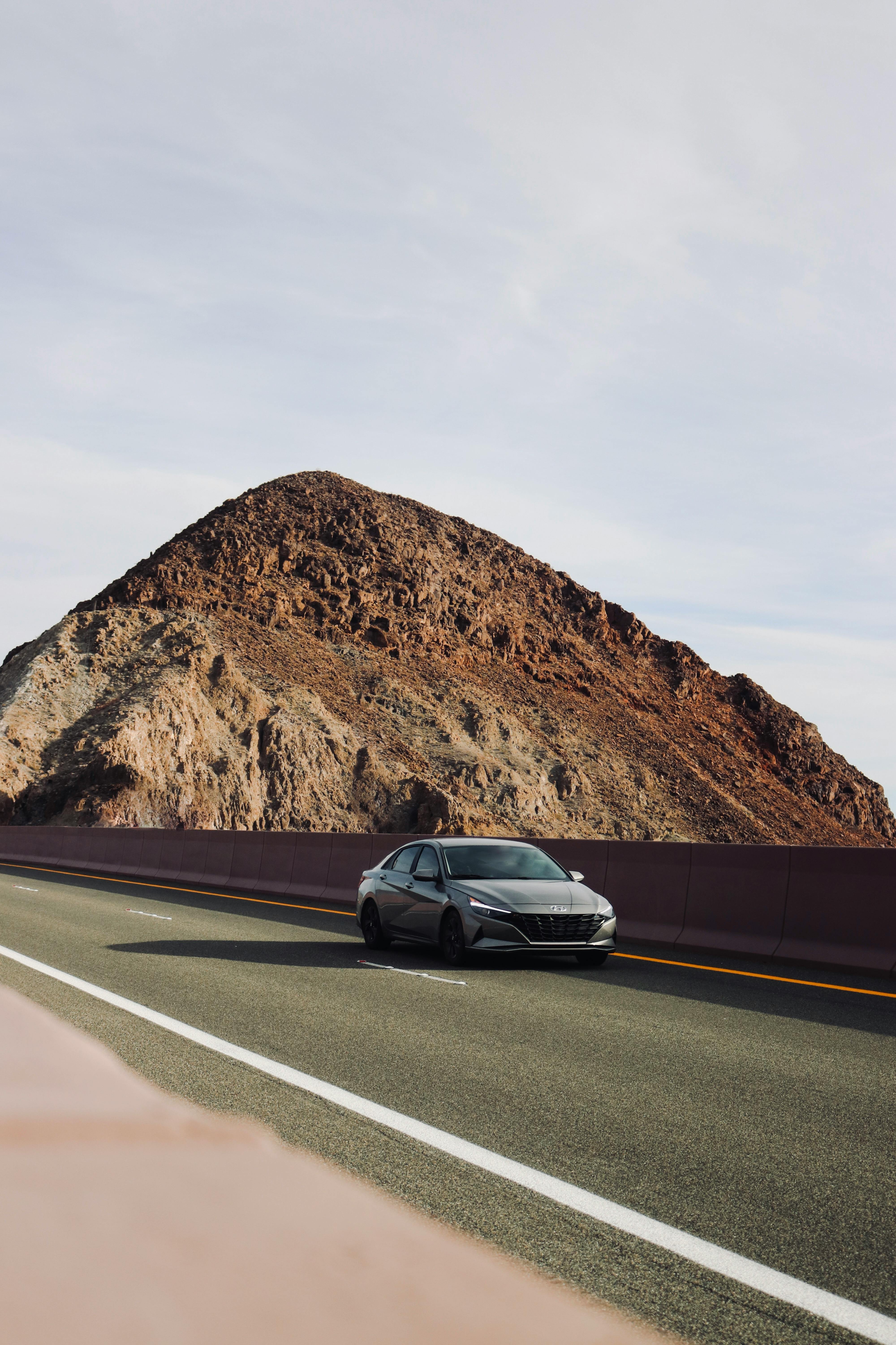 Car on a Road by the Mountain · Free