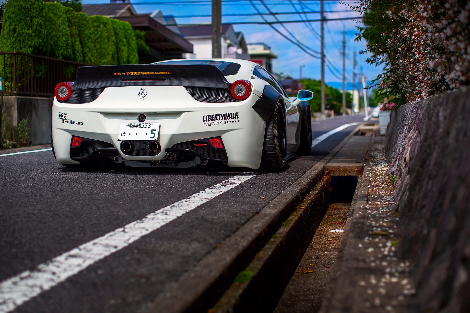 A beautiful white car is driving along the road for your phone