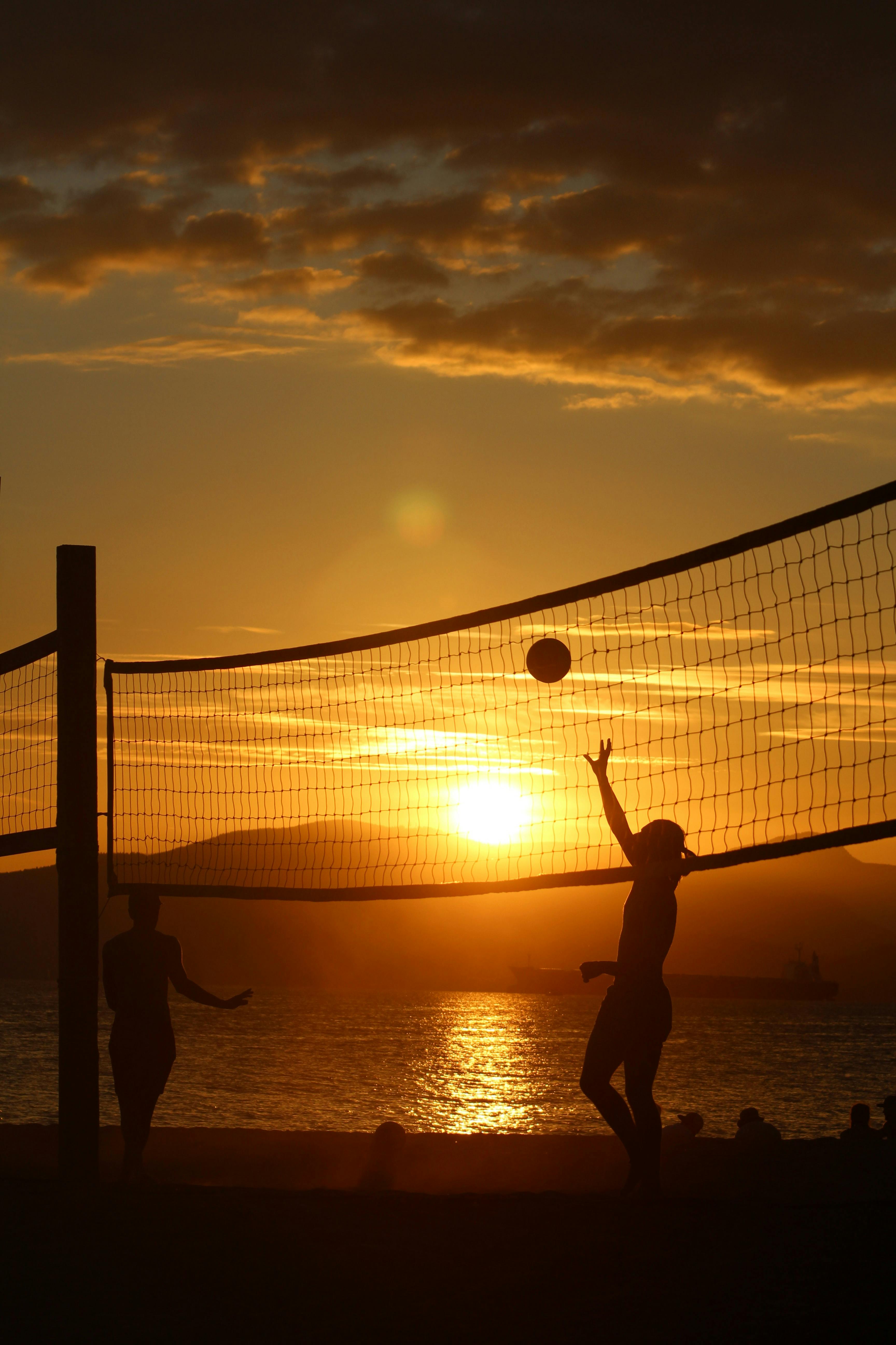 Silhouette of People Playing Volleyball on the Beach During Sunset · Free