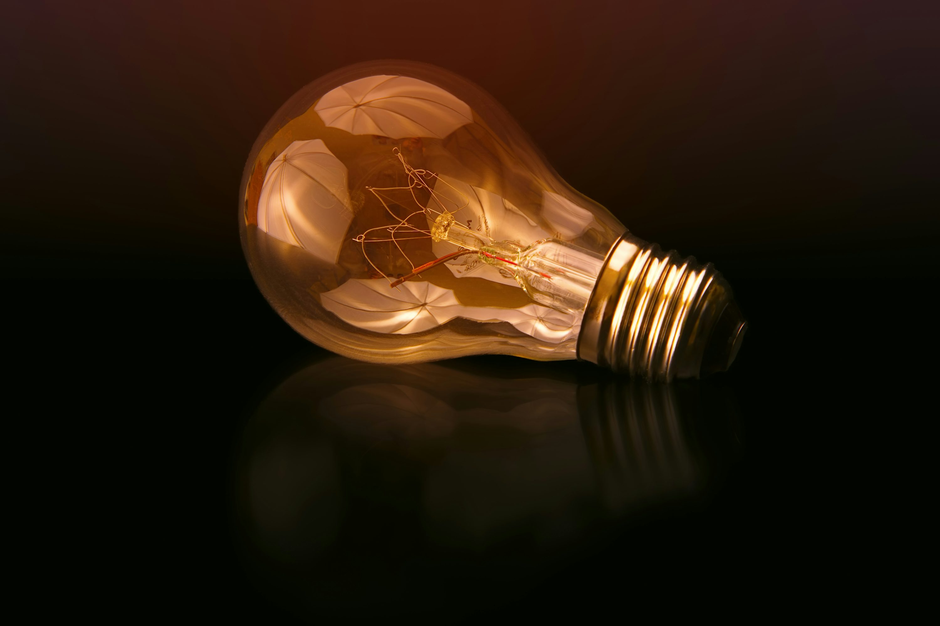 Incandescent bulb on black surface photo
