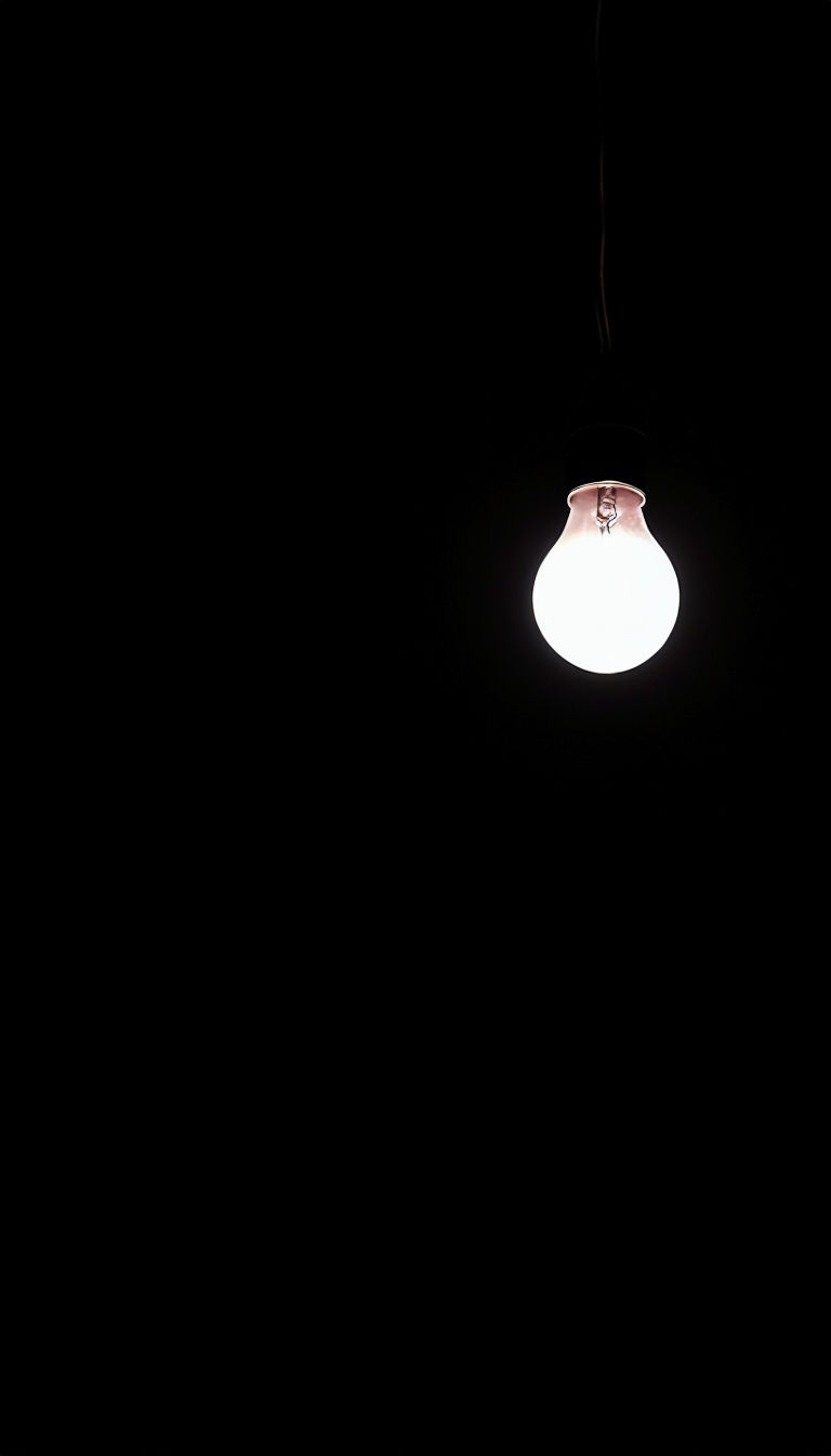 Minimalist Incandescent Light Bulb Against Black Background Mobile Wallpaper