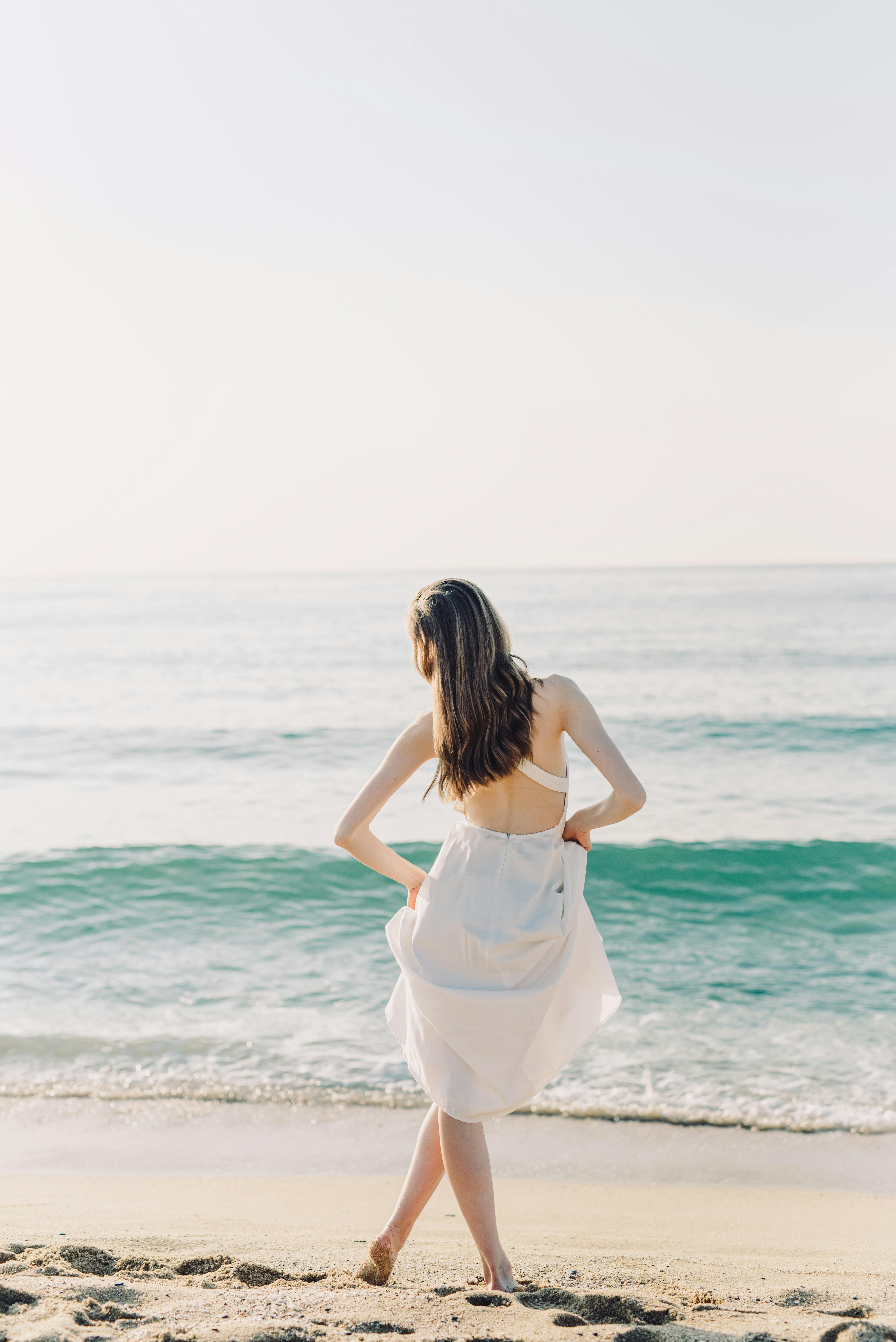 Woman in White Dress Posing at a Beach · Free