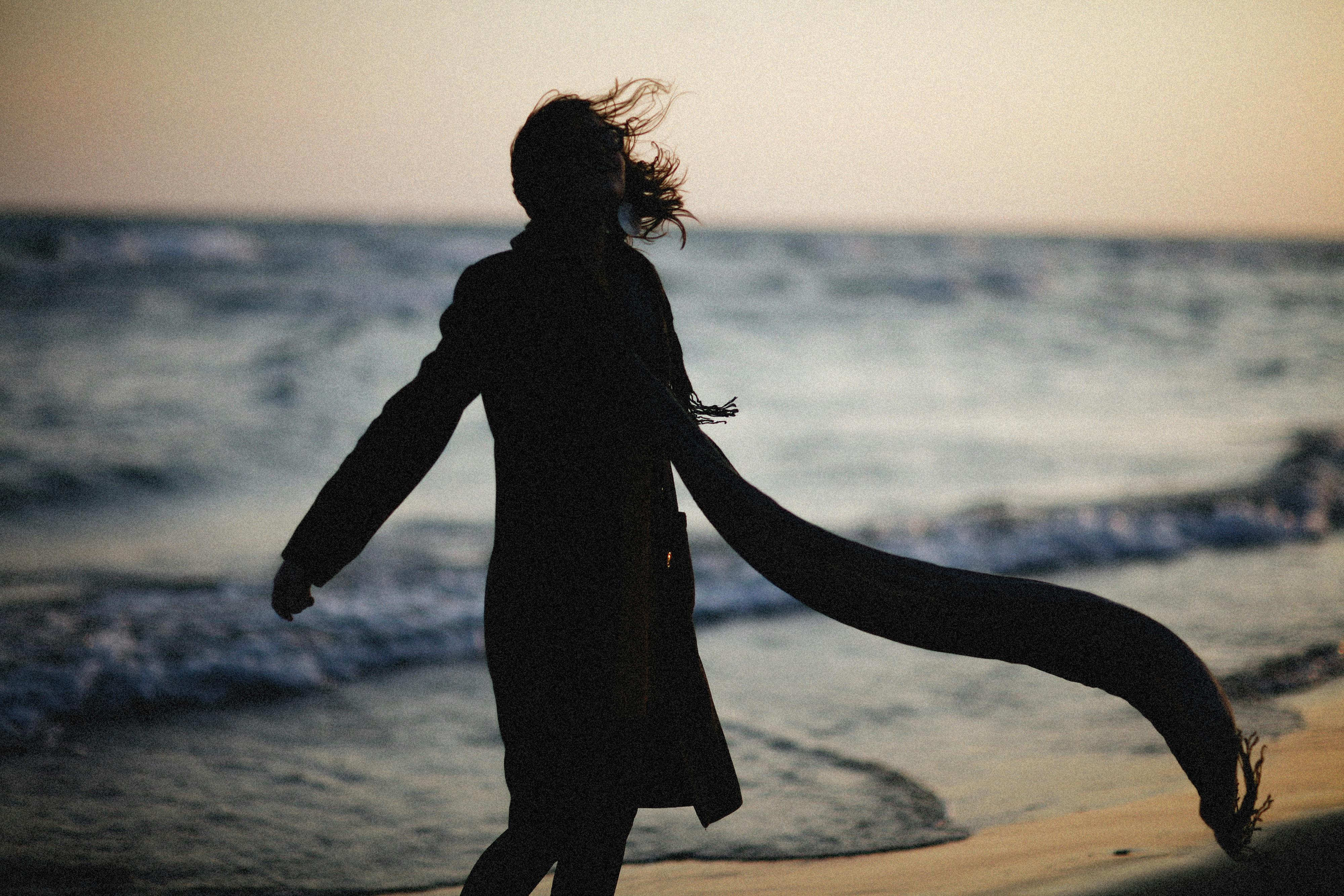 Silhouette of a Woman at the Beach · Free