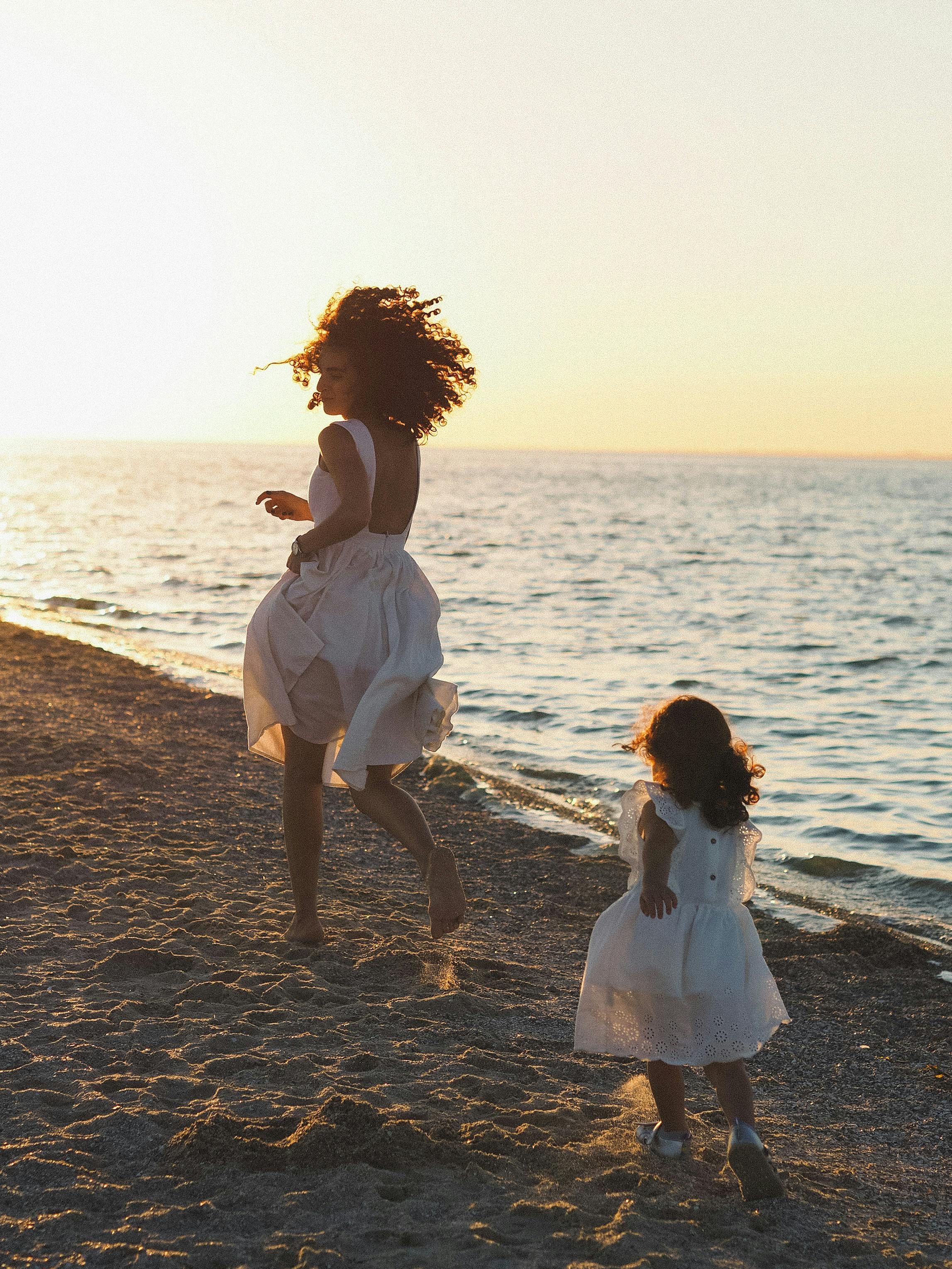 Mother and Daughter Running on a Beach · Free